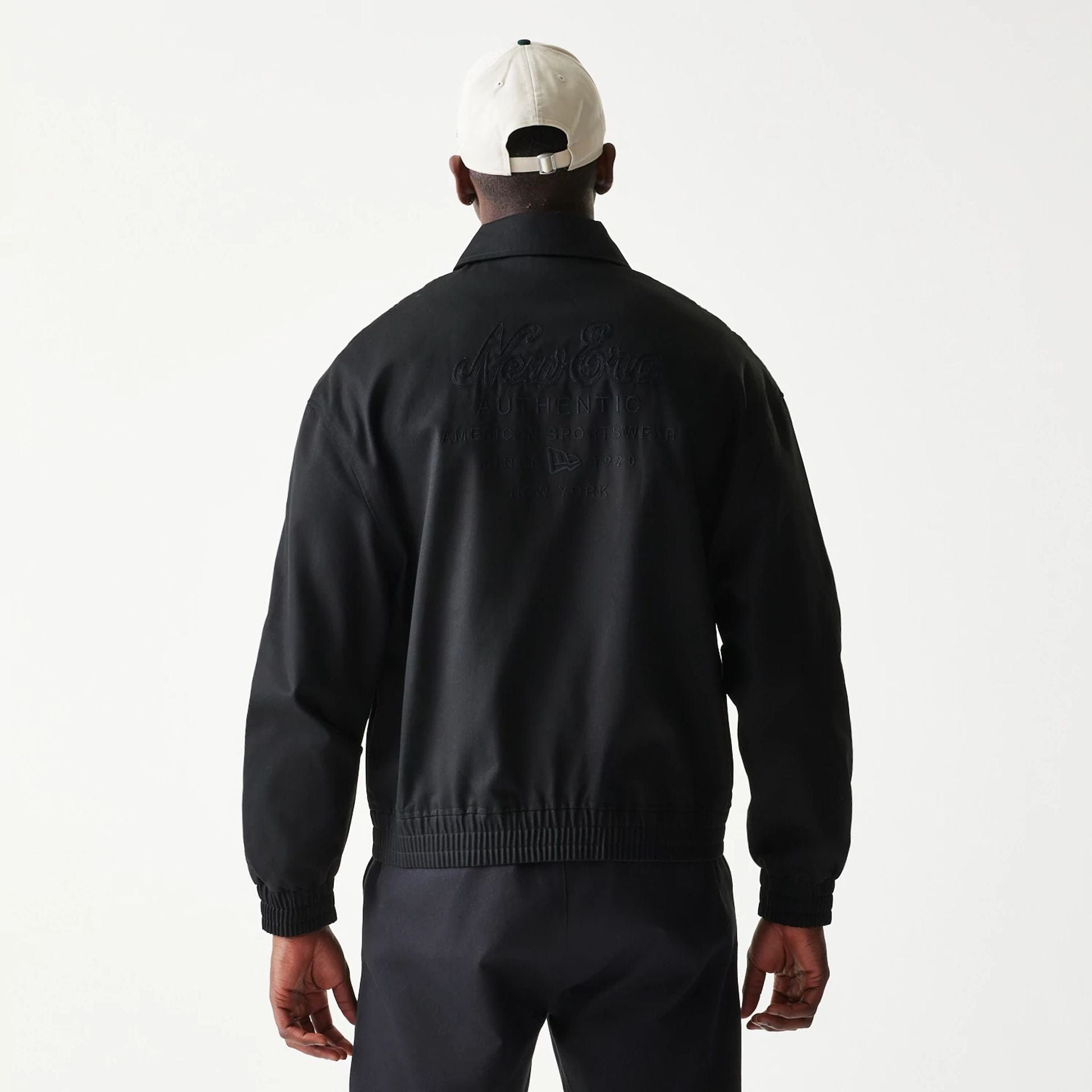 The model is wearing this New Era Collared Jacket in black. 2