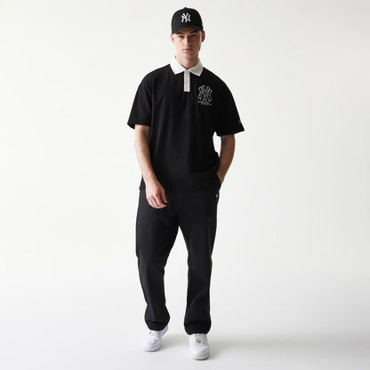 The model is wearing this MLB New York Yankees Oversized Polo T-Shirt in black. 8