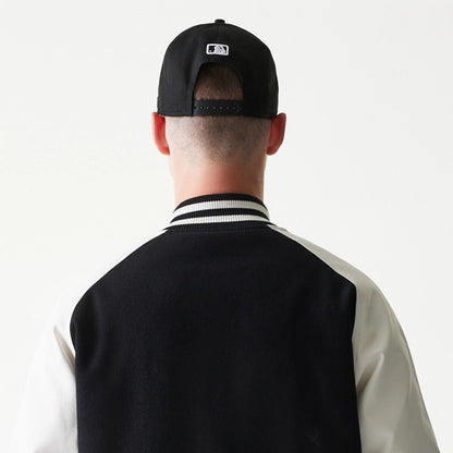 The model is wearing this MLB New York Yankees Varsity Jacket in black. 7