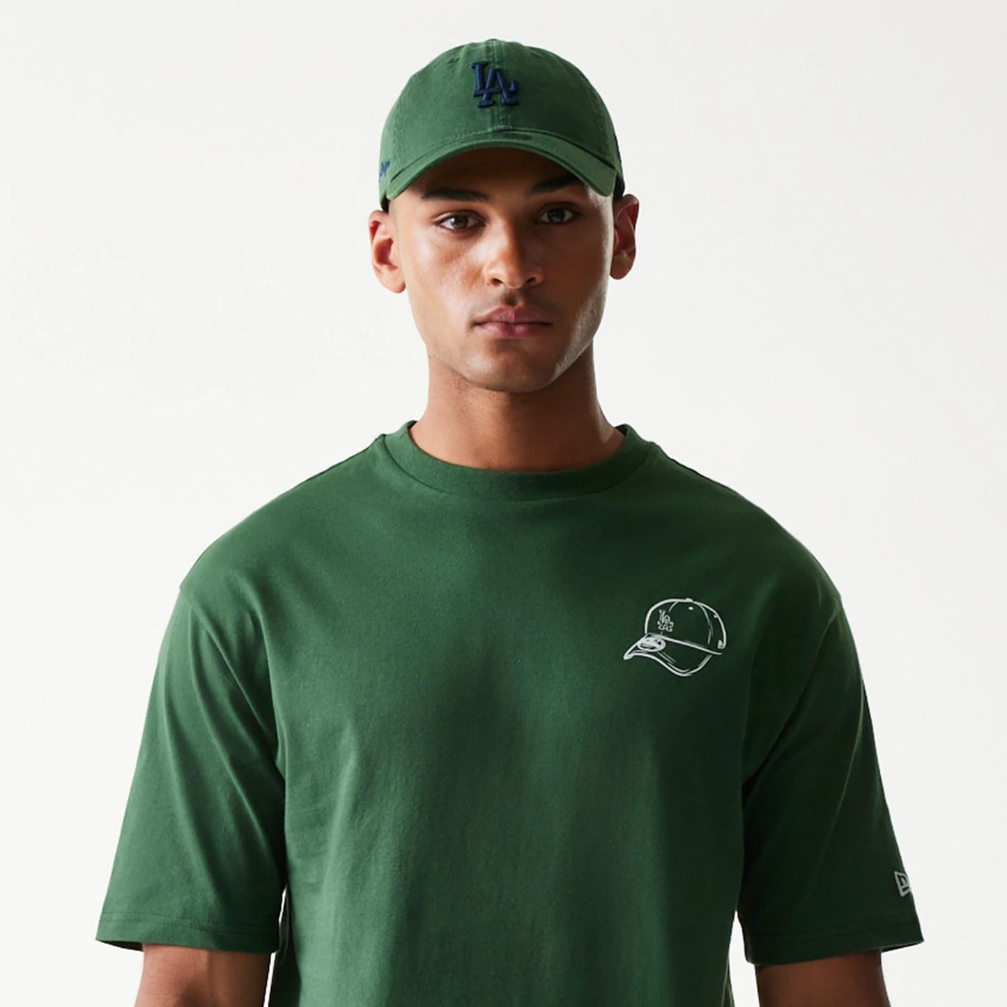 The model is wearing this MLB Baseball Graphic LA Dodgers Oversized T-Shirt in dark green. 5