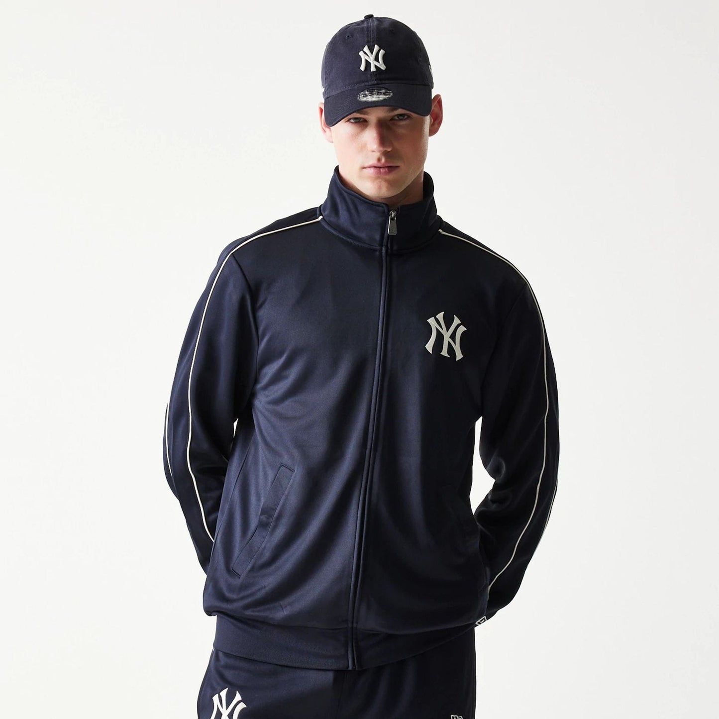 The model is wearing this MLB Piping New York Yankees Track Jacket in navy. 3