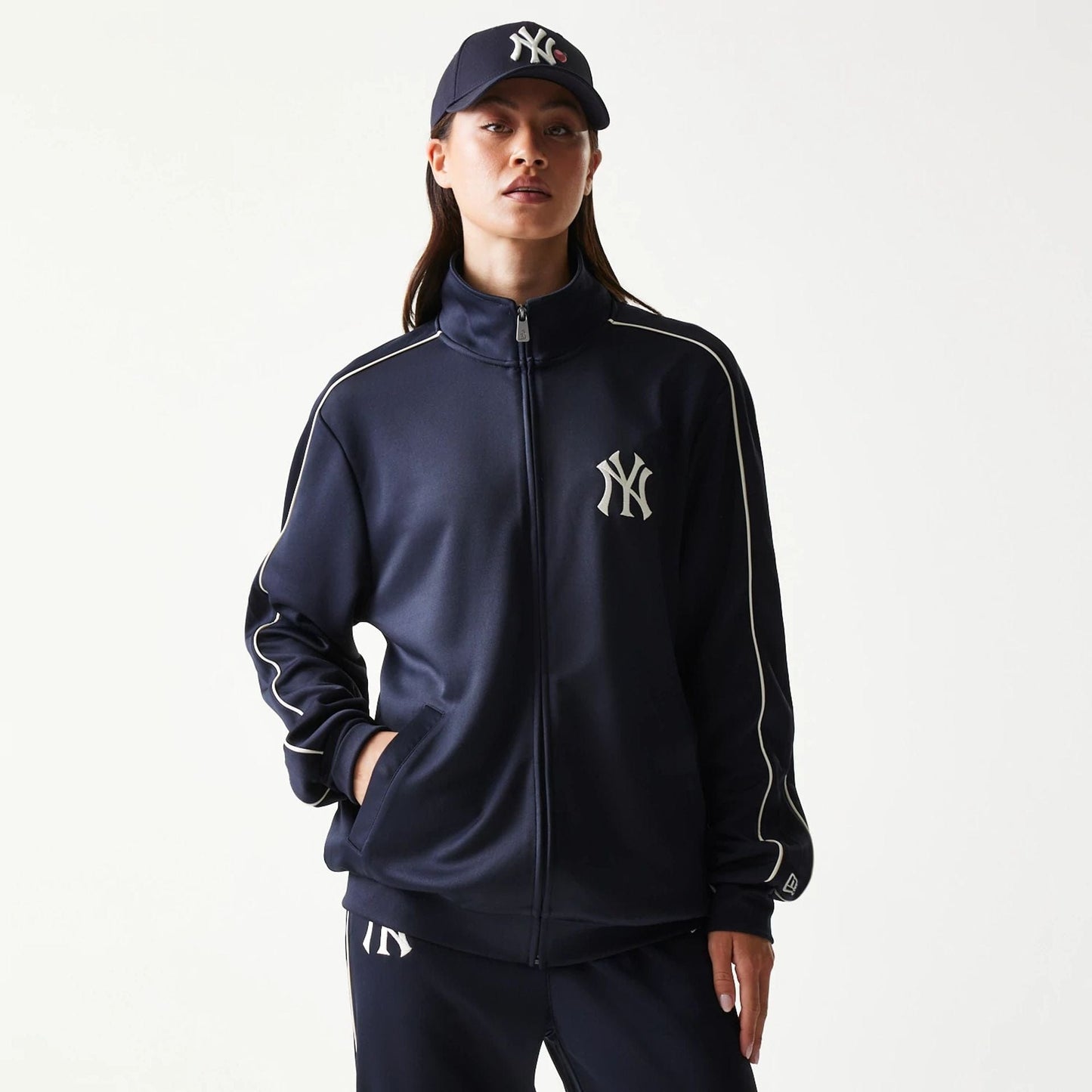 The model is wearing this MLB Piping New York Yankees Track Jacket in navy. 4