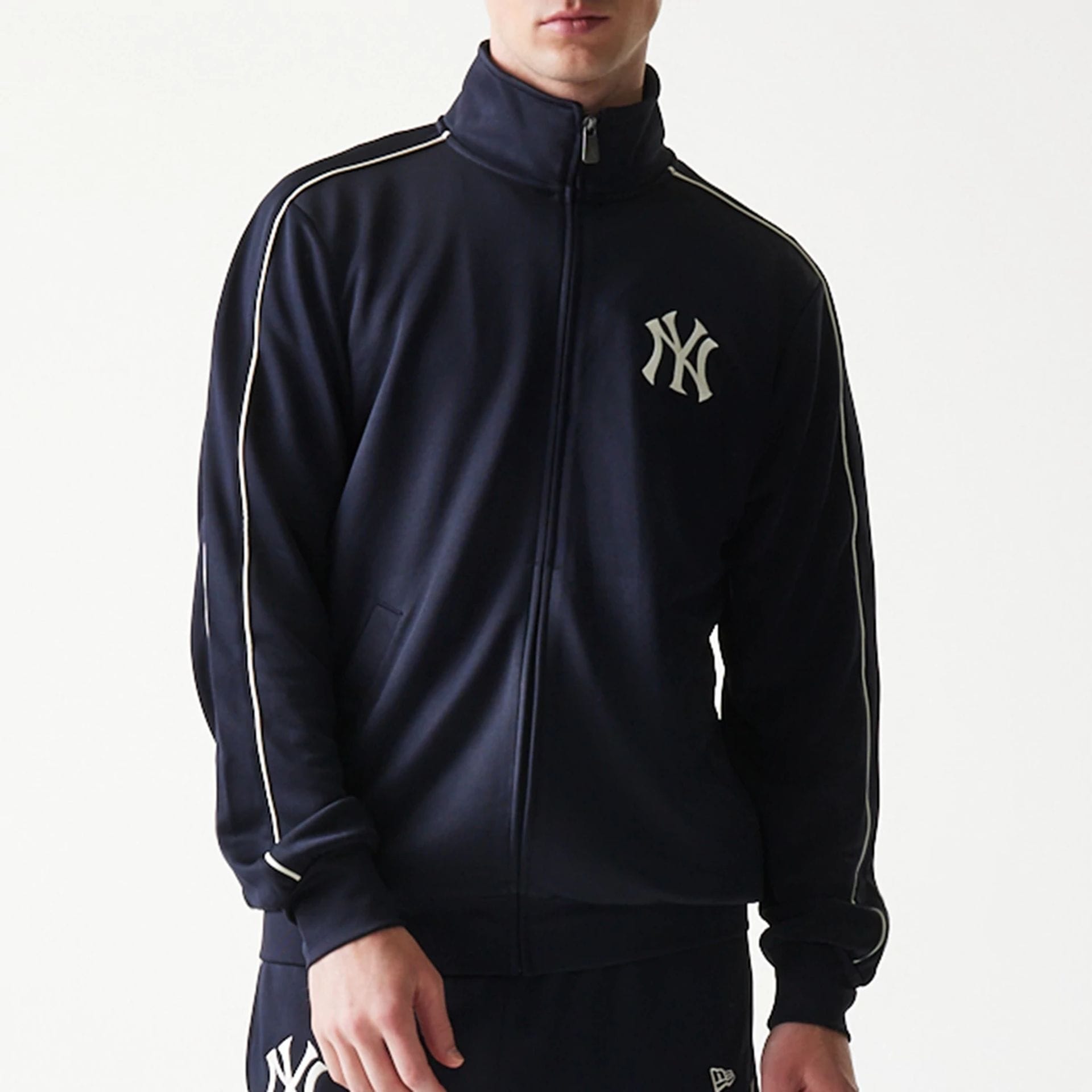 The model is wearing this MLB Piping New York Yankees Track Jacket in navy. 8