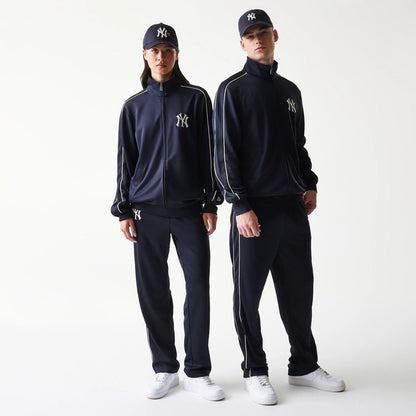 The model is wearing this MLB Piping New York Yankees Track Jacket in navy. 1