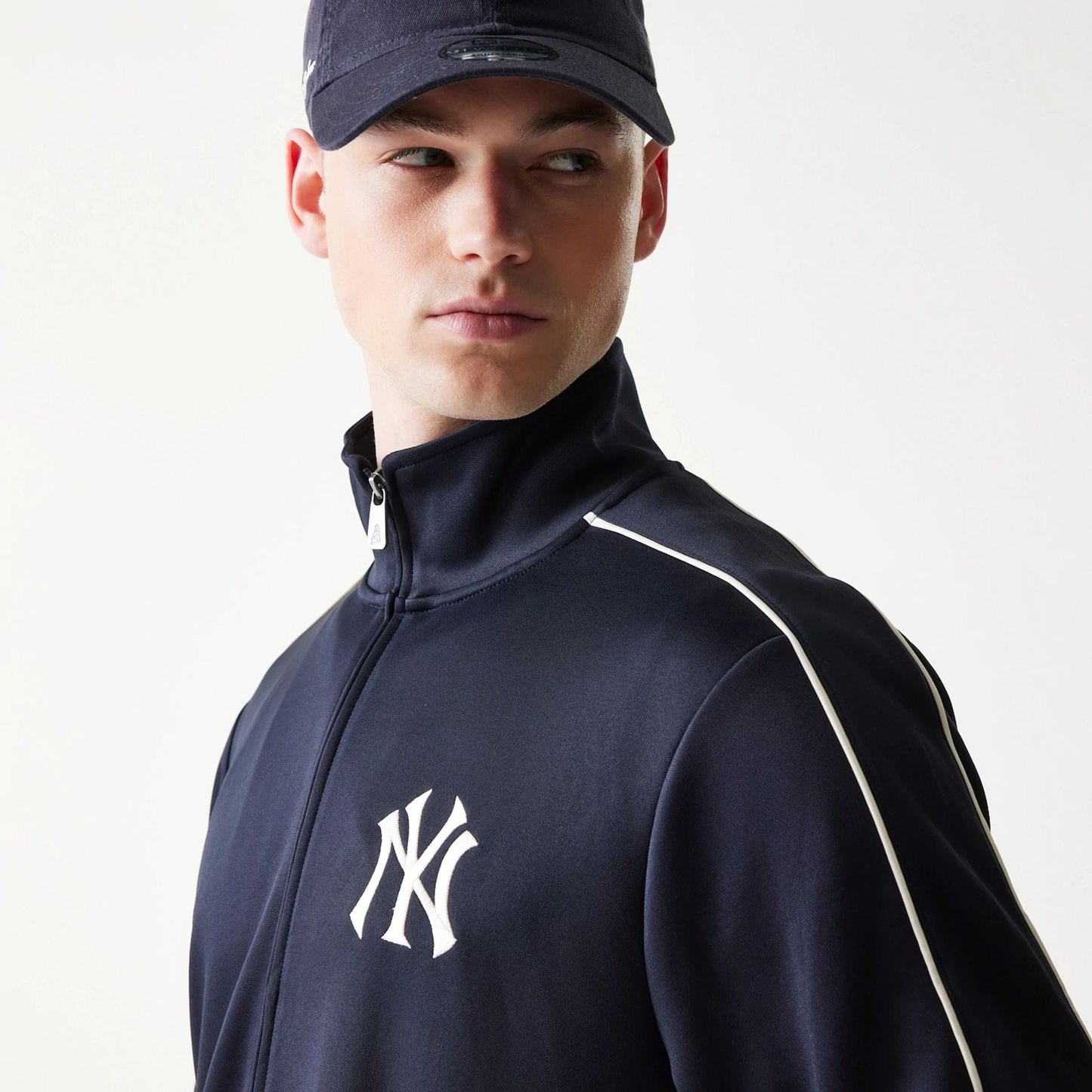 The model is wearing this MLB Piping New York Yankees Track Jacket in navy. 5
