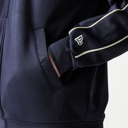 The model is wearing this MLB Piping New York Yankees Track Jacket in navy. 6