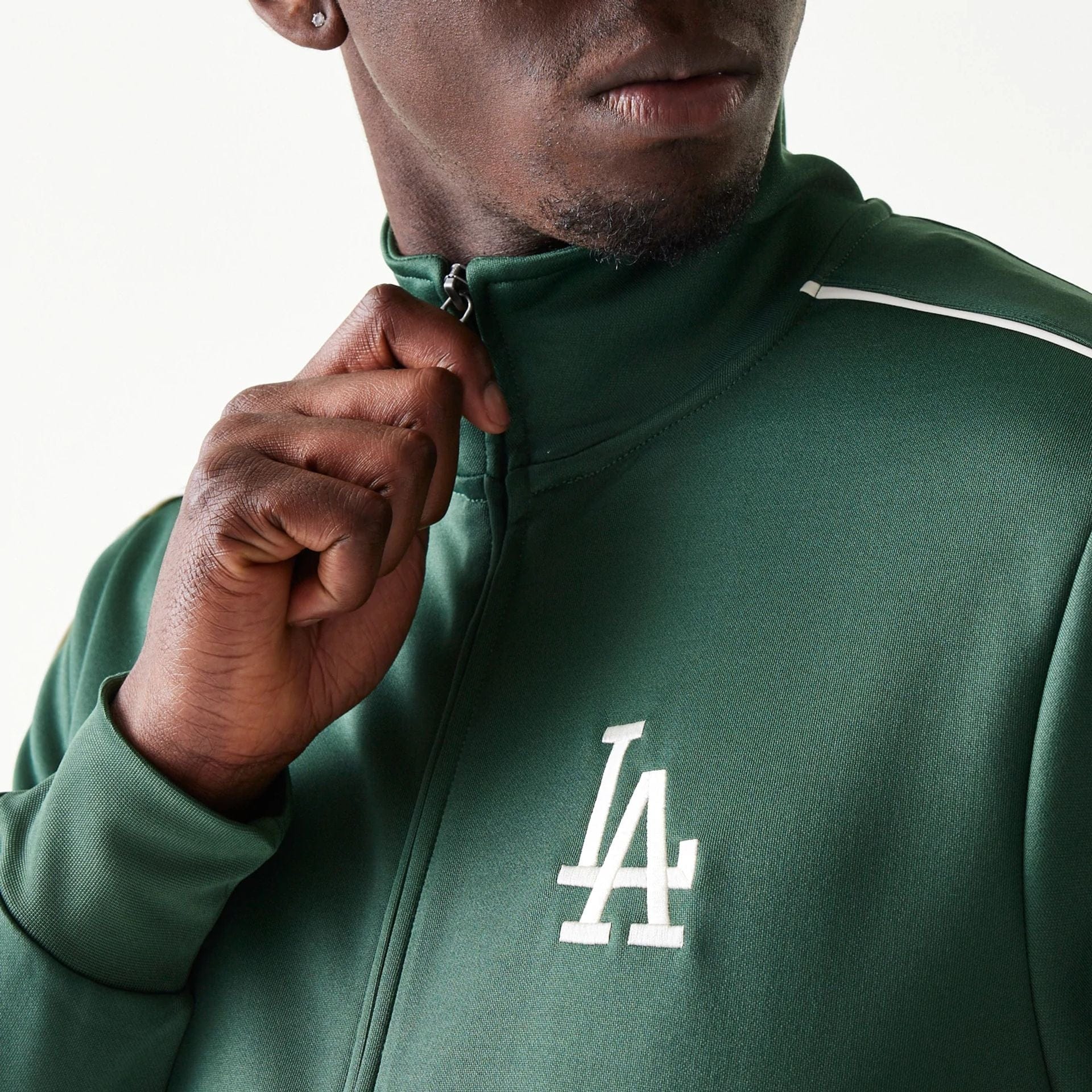 The model is wearing this MLB Piping LA Dodgers Track Jacket in dark green. 4