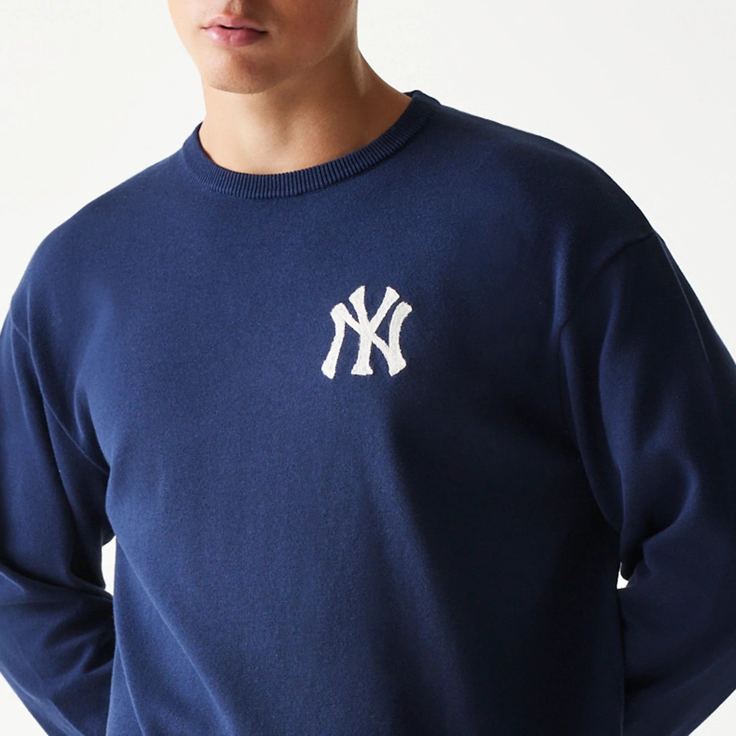 The model is wearing this MLB Essential New York Yankees Knitted Sweater in navy. 8