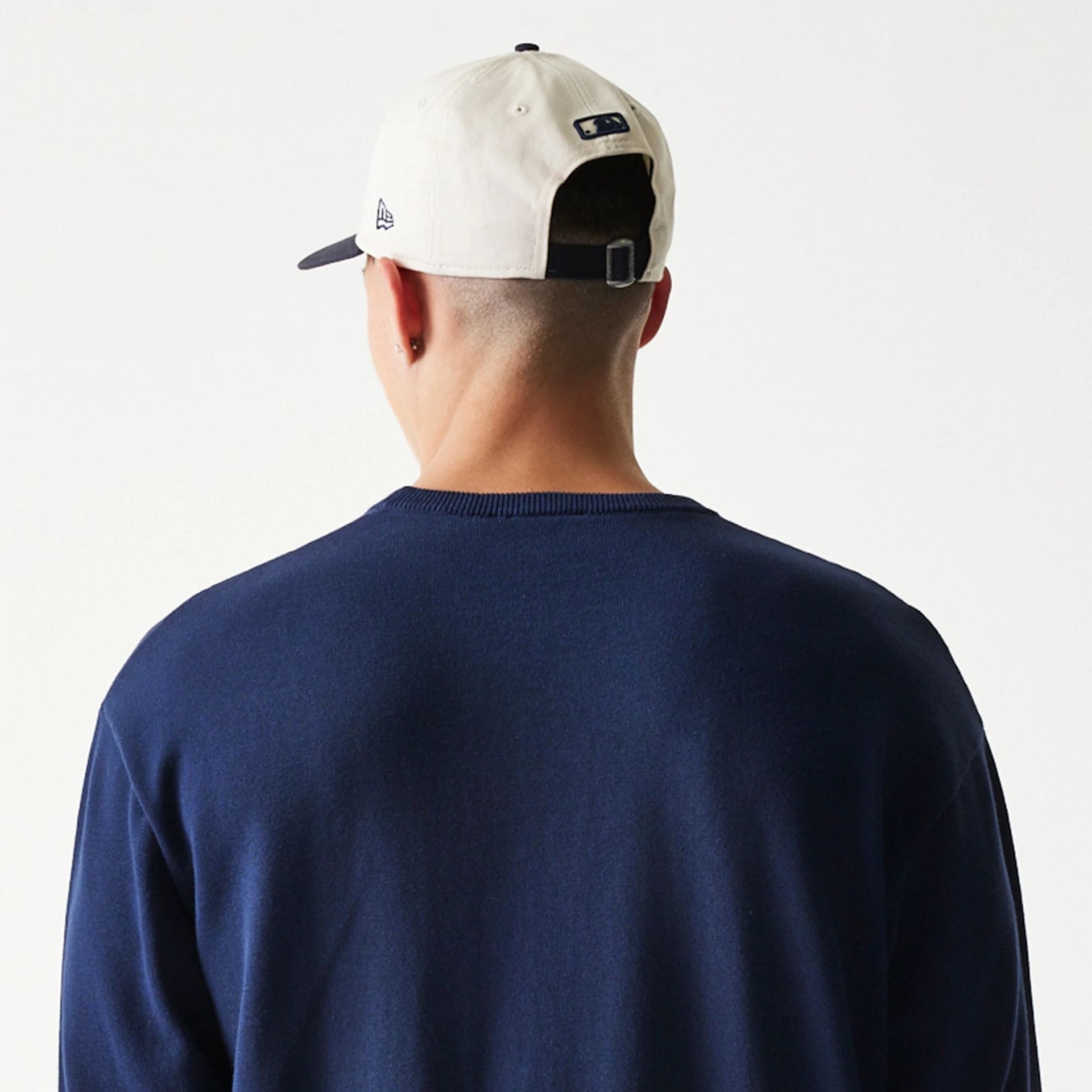 The model is wearing this MLB Essential New York Yankees Knitted Sweater in navy. 7