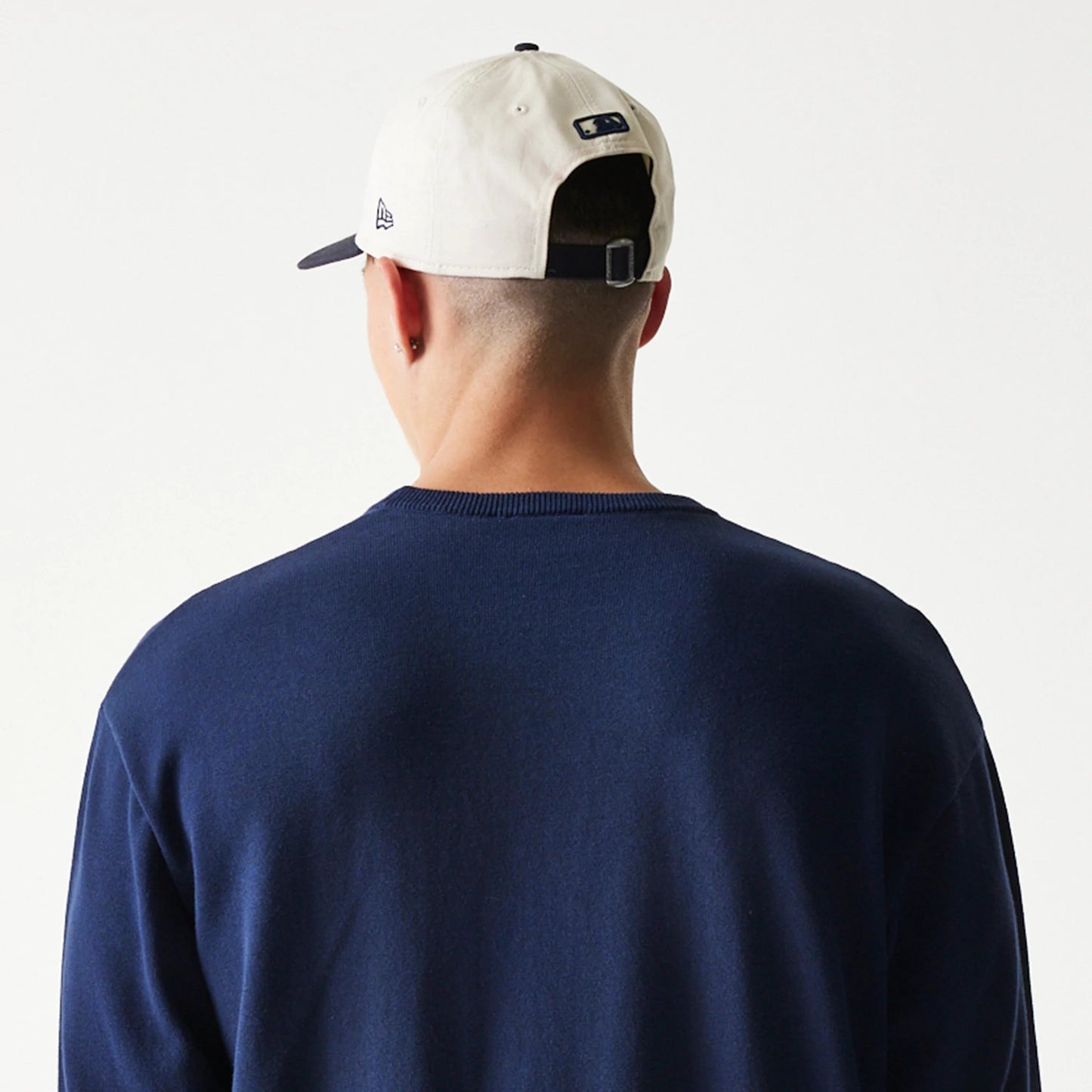 The model is wearing this MLB Essential New York Yankees Knitted Sweater in navy. 7