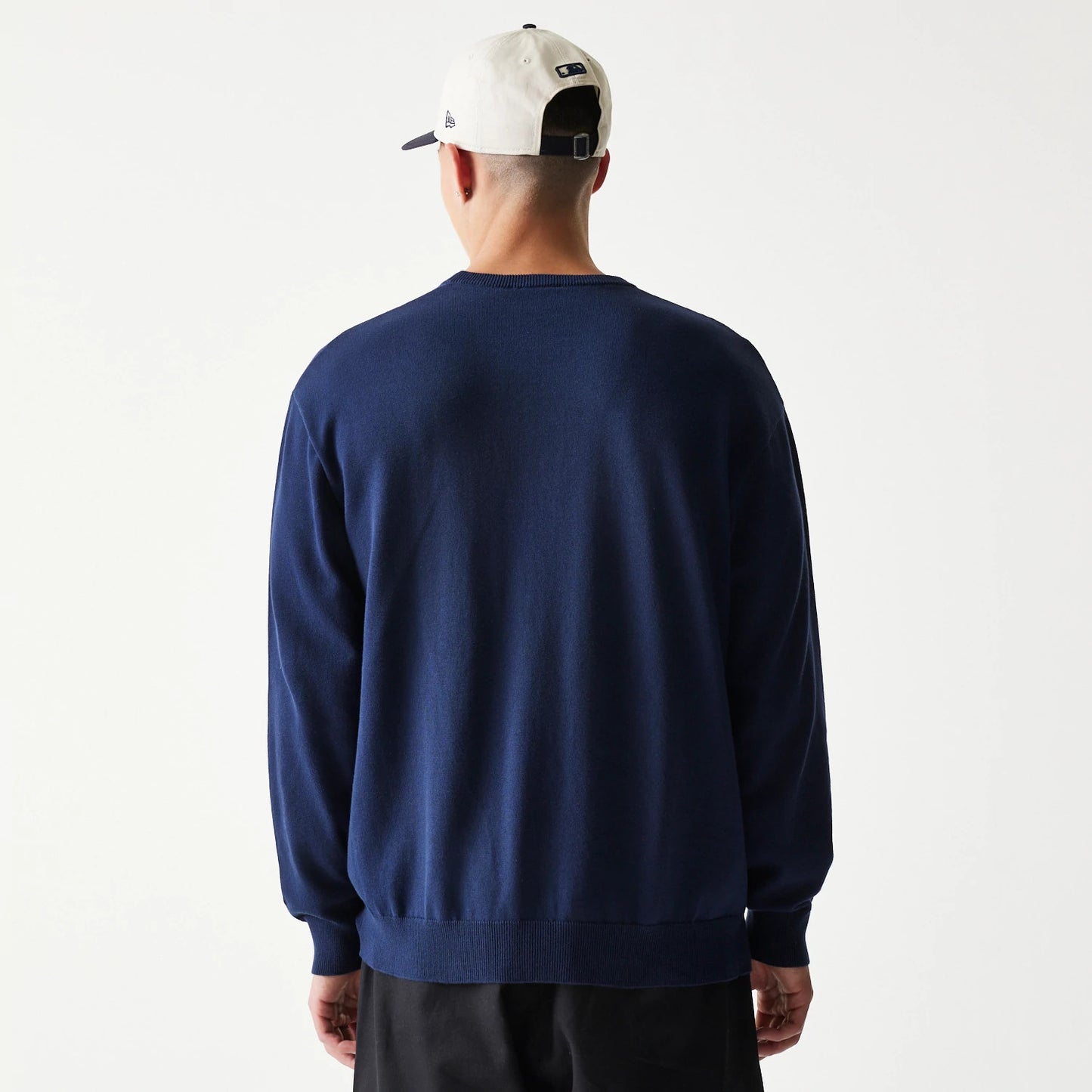 The model is wearing this MLB Essential New York Yankees Knitted Sweater in navy. 2