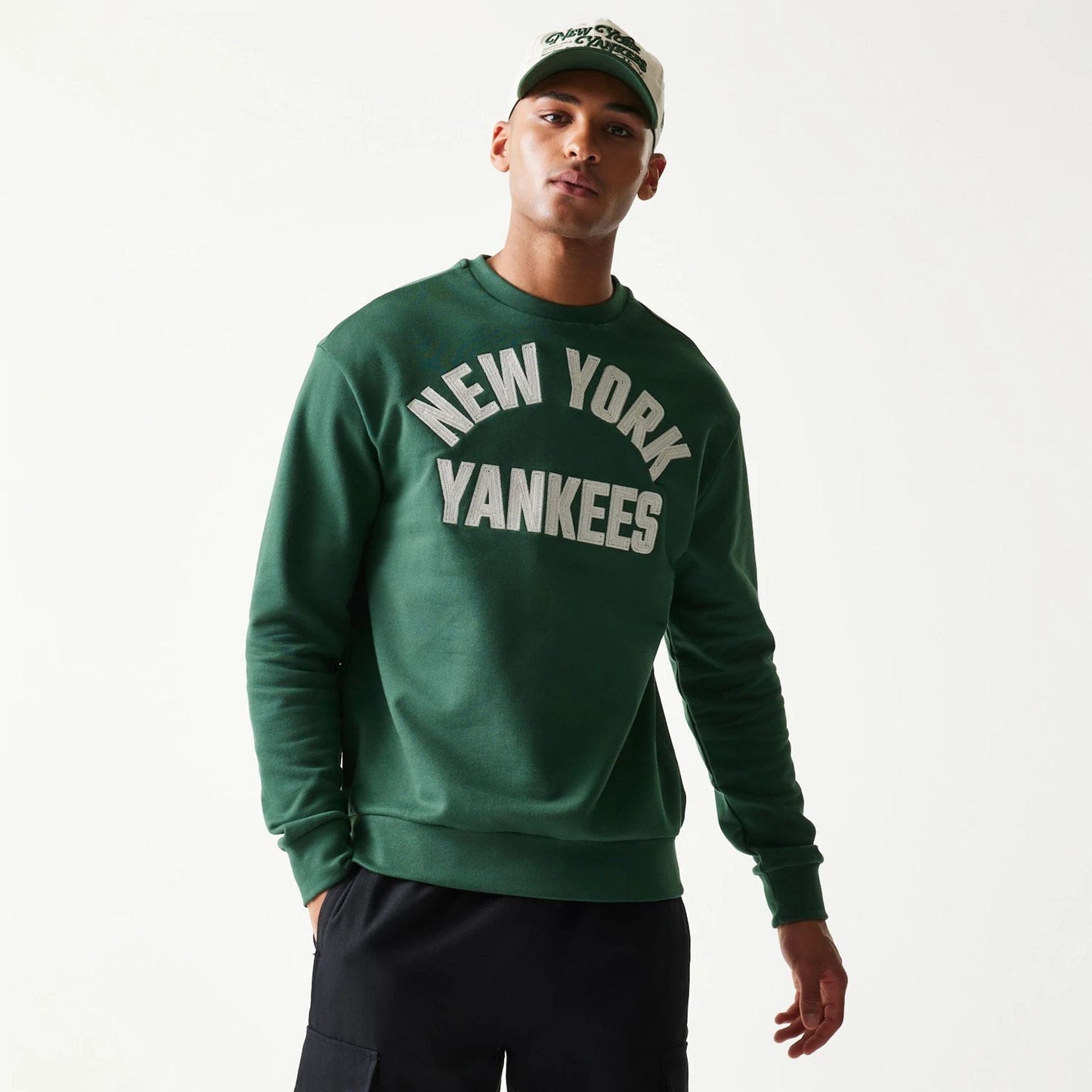 The model is wearing this MLB Graphic New York Yankees Oversized Crew Neck Sweater in dark green. 3