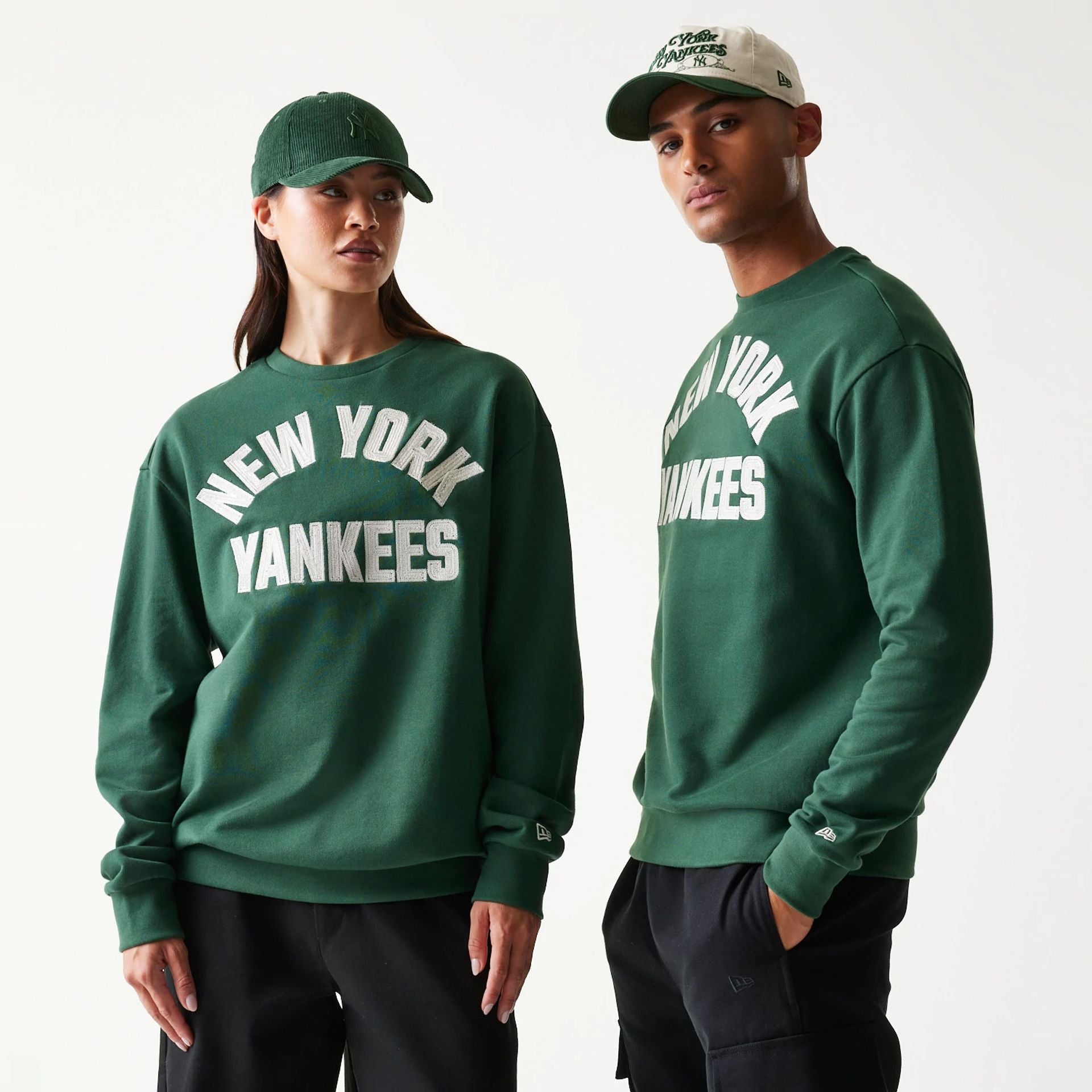 The model is wearing this MLB Graphic New York Yankees Oversized Crew Neck Sweater in dark green. 1