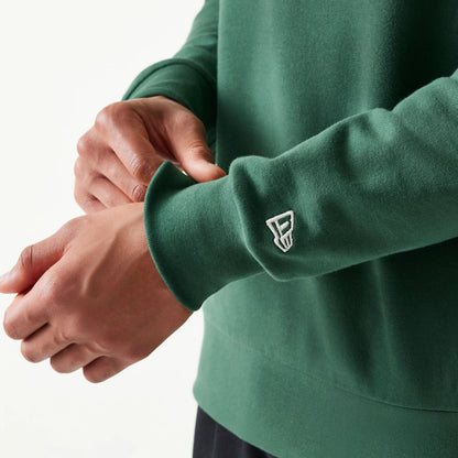 The model is wearing this MLB Graphic New York Yankees Oversized Crew Neck Sweater in dark green. 7