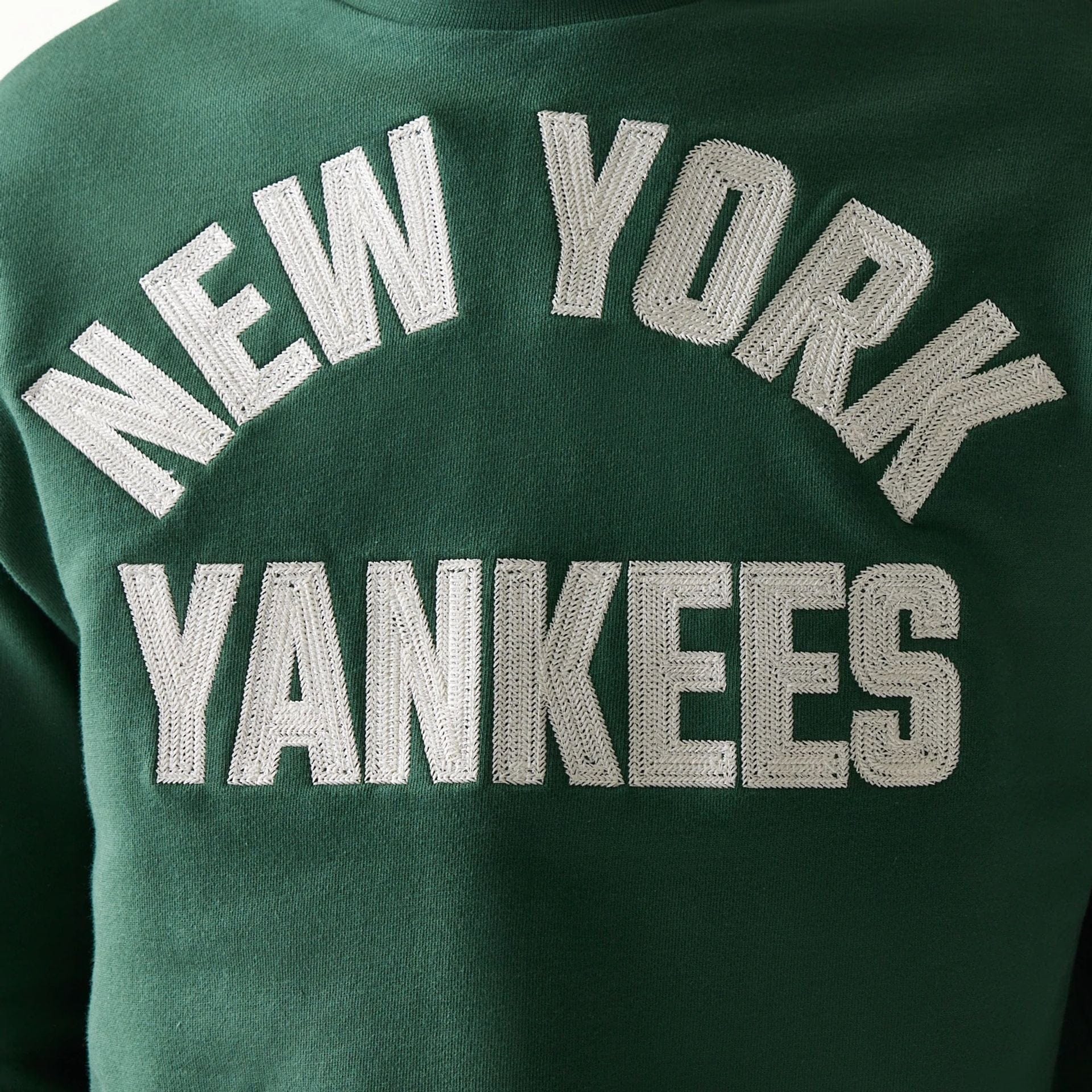 The model is wearing this MLB Graphic New York Yankees Oversized Crew Neck Sweater in dark green. 8