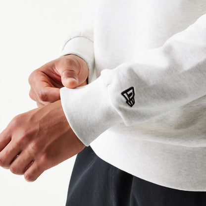 The model is wearing this MLB Graphic New York Yankees Oversized Crew Neck Sweater in pastel grey. 7