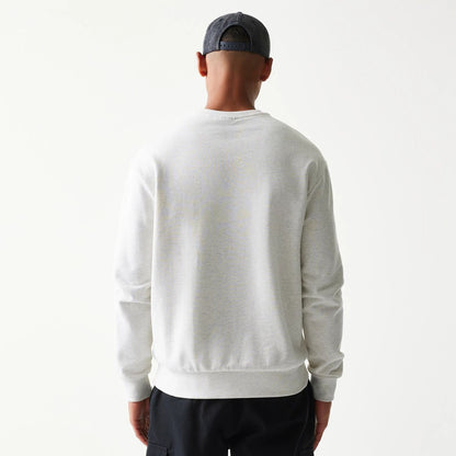 The model is wearing this MLB Graphic New York Yankees Oversized Crew Neck Sweater in pastel grey. 2