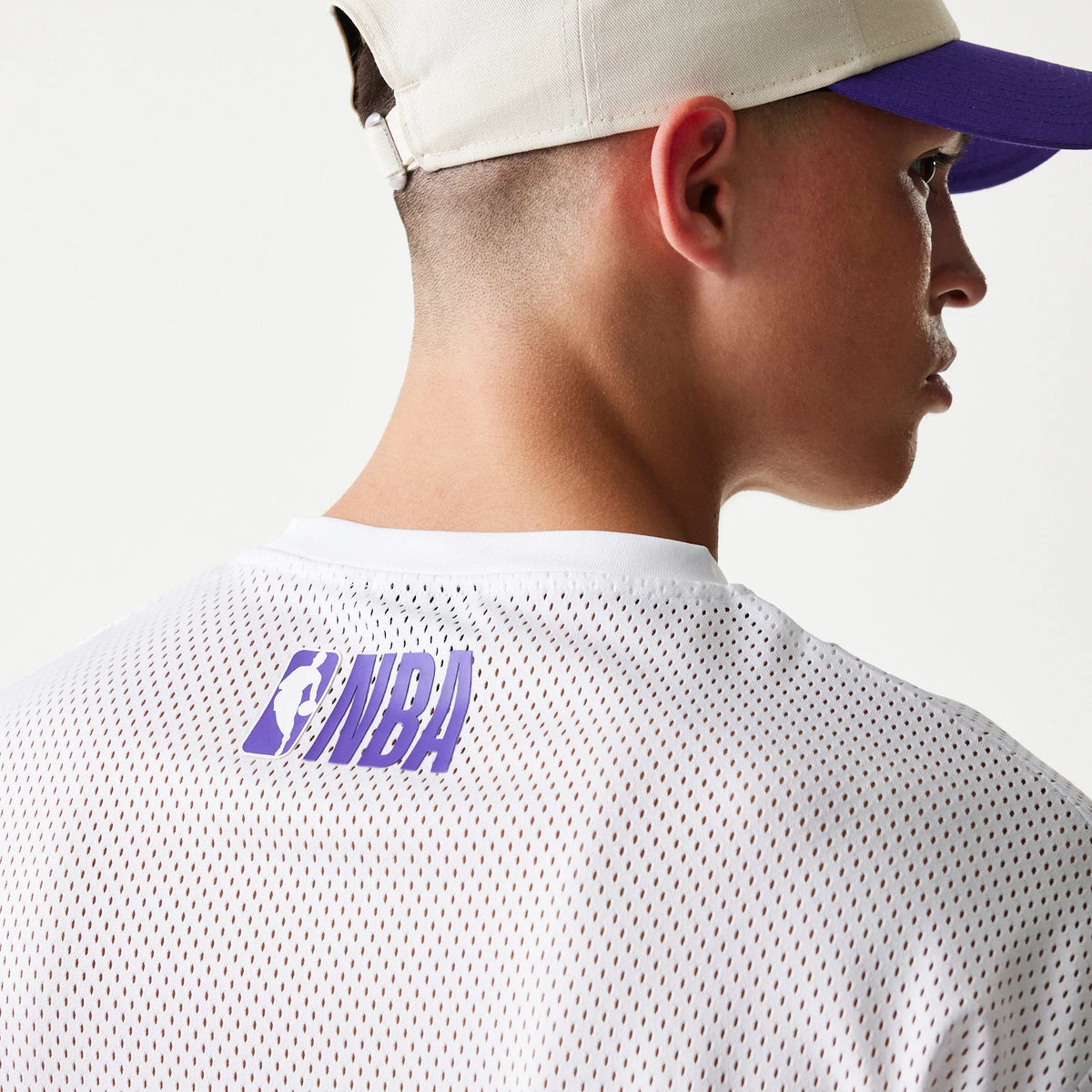 The model is wearing this NBA Graphic Mesh LA Lakers T-Shirt in white. 6