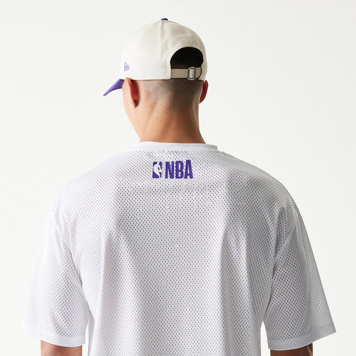 The model is wearing this NBA Graphic Mesh LA Lakers T-Shirt in white. 7