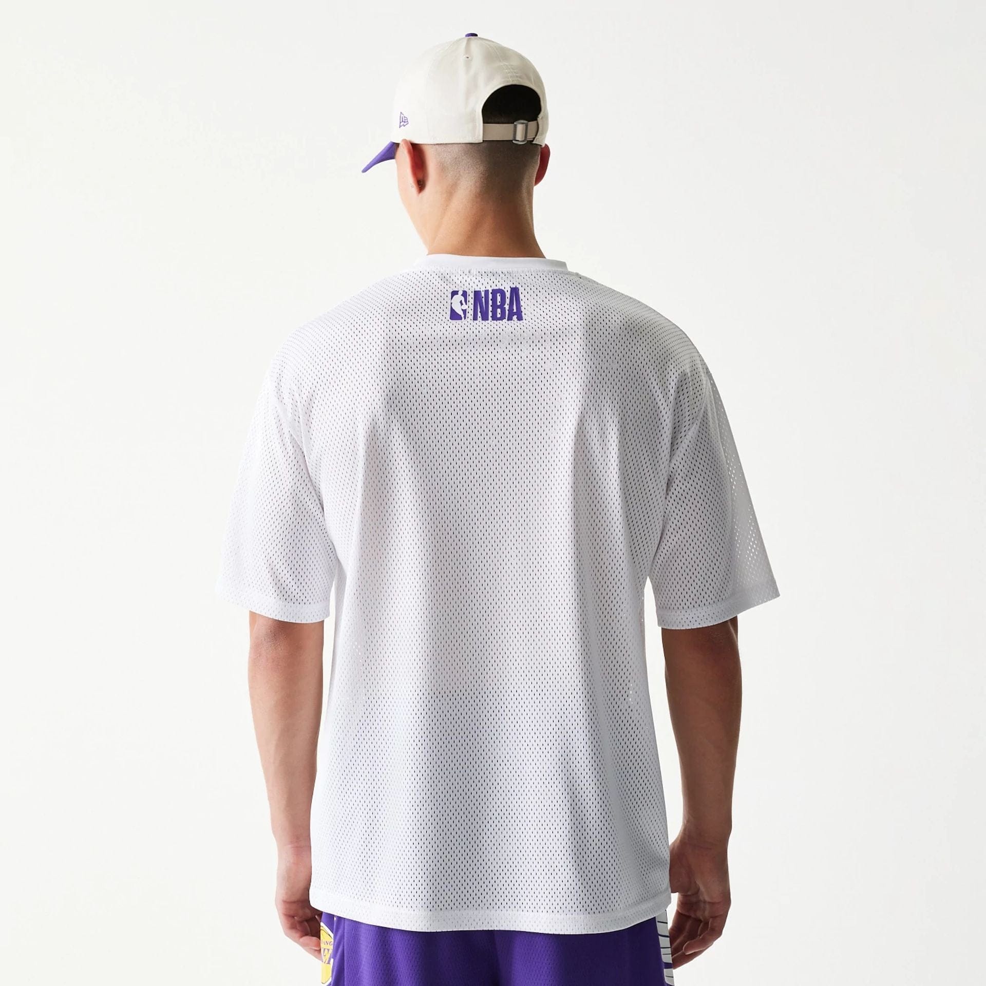 The model is wearing this NBA Graphic Mesh LA Lakers T-Shirt in white. 2