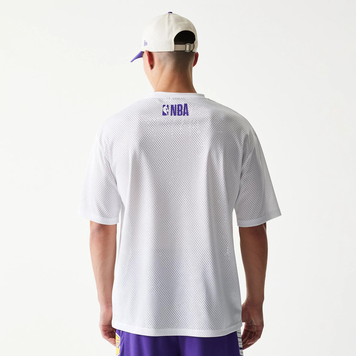 The model is wearing this NBA Graphic Mesh LA Lakers T-Shirt in white. 2