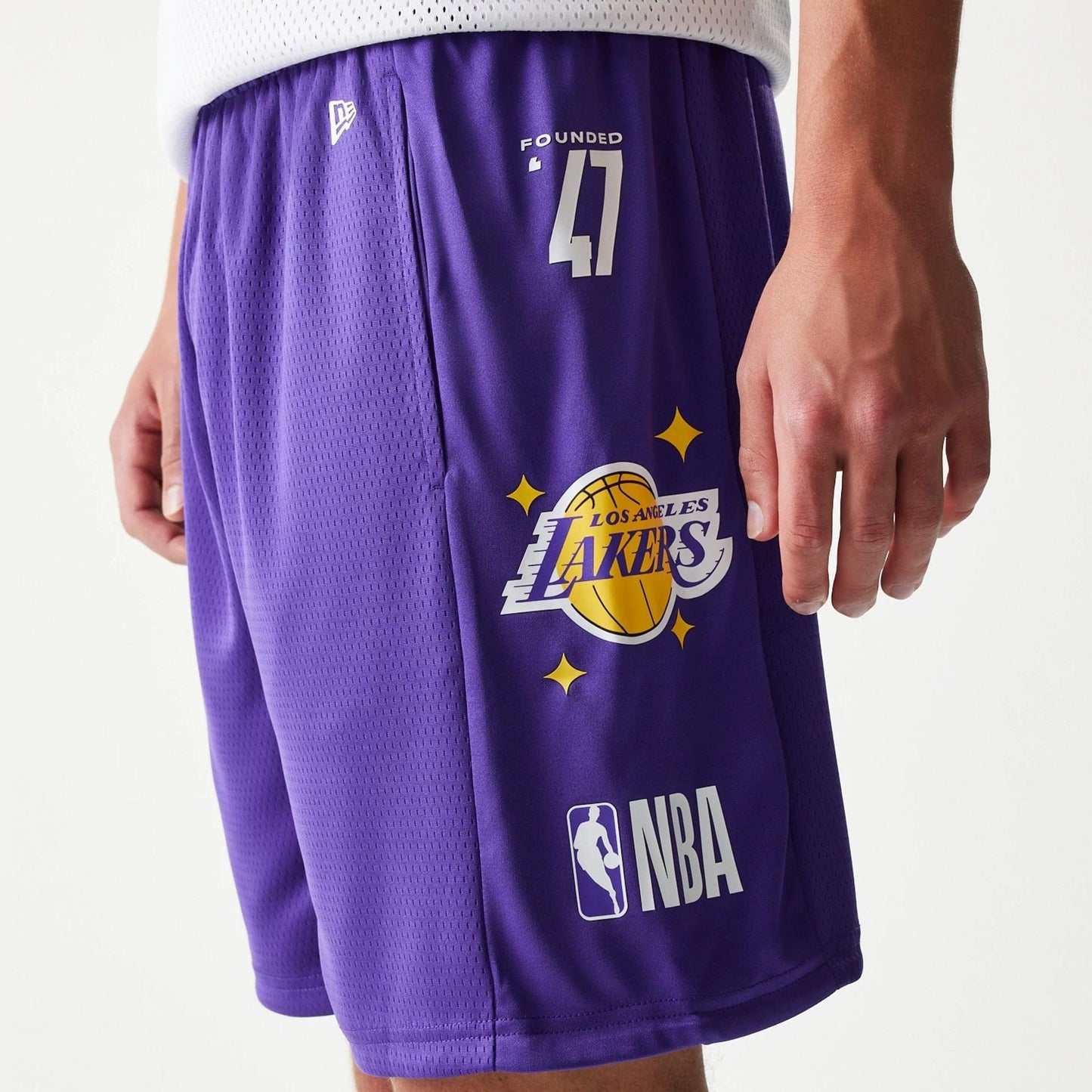 The model is wearing this NBA Mesh LA Lakers Shorts in purple. 6