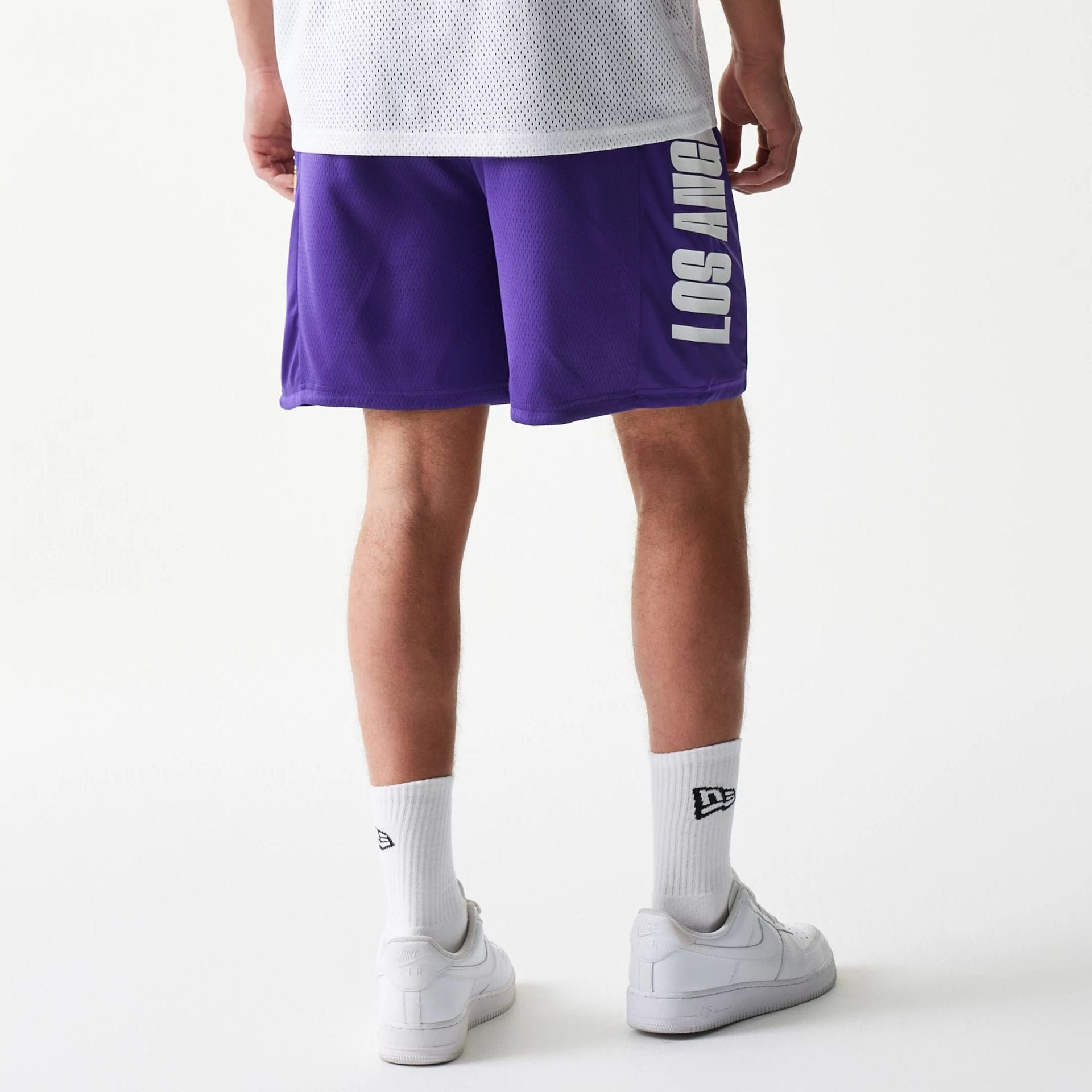 The model is wearing this NBA Mesh LA Lakers Shorts in purple. 2