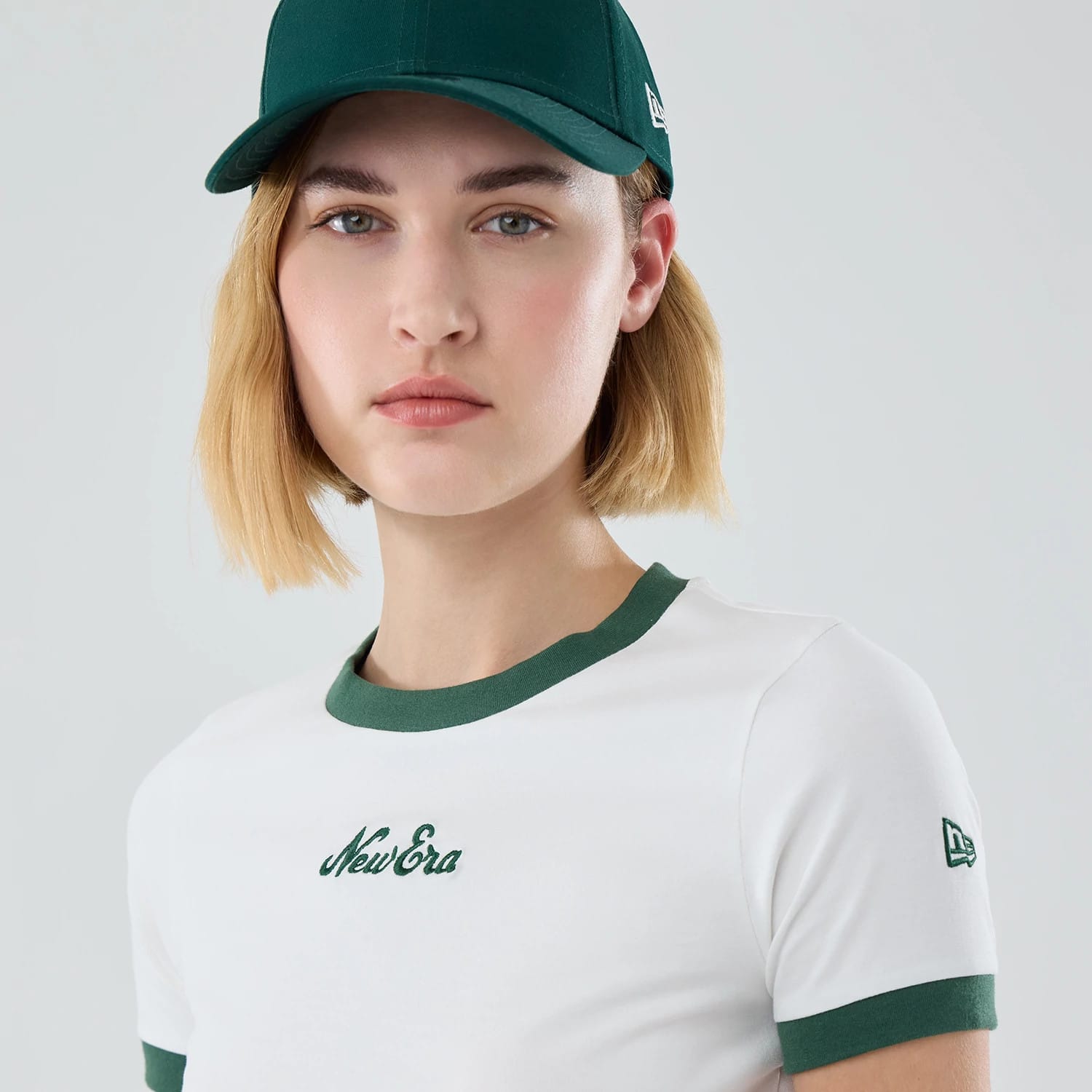 The model is wearing this Womens New Era Cropped Slim T-shirt in white. 6