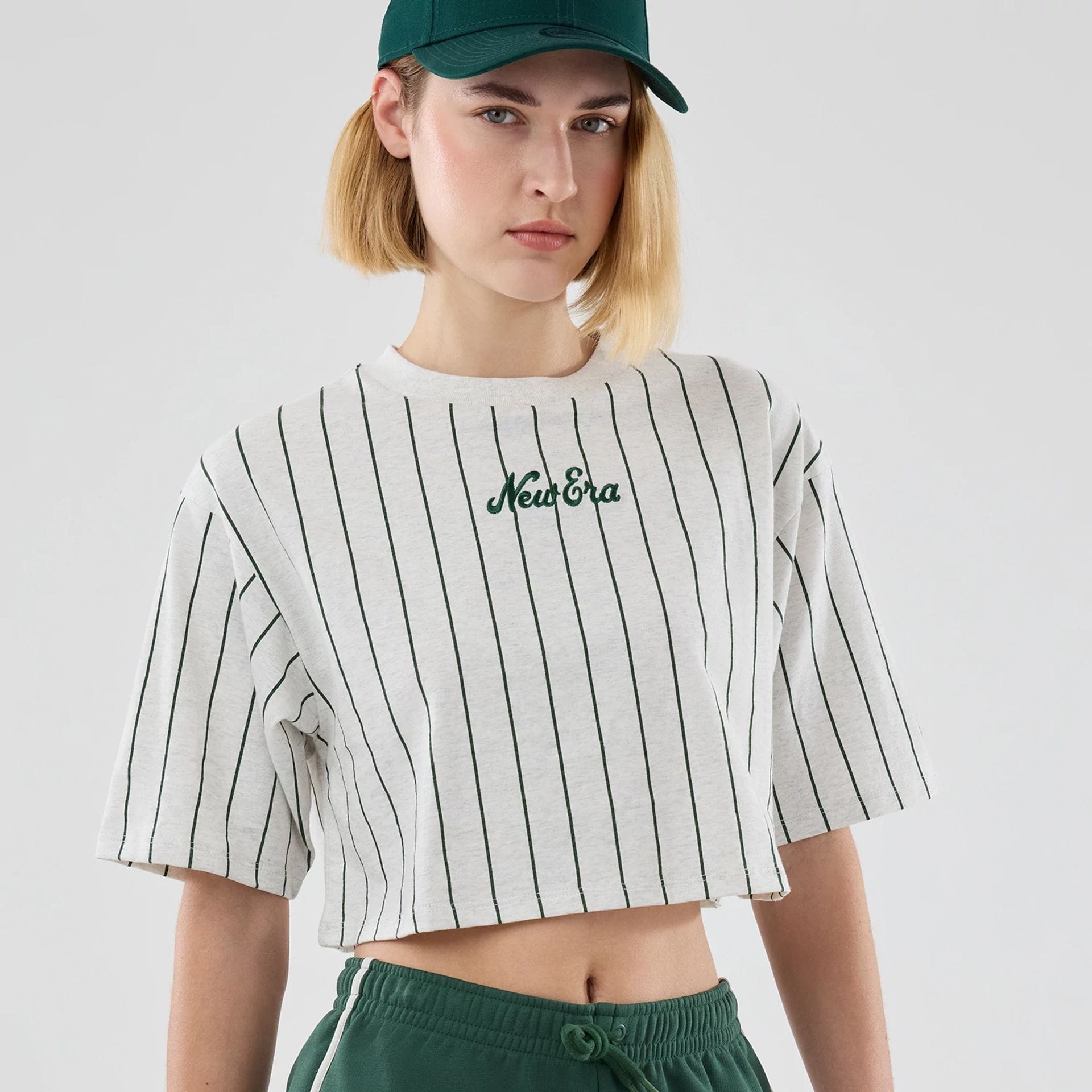 The model is wearing this Womens New Era Pinstripe Cropped T-shirt in pastel grey. 3