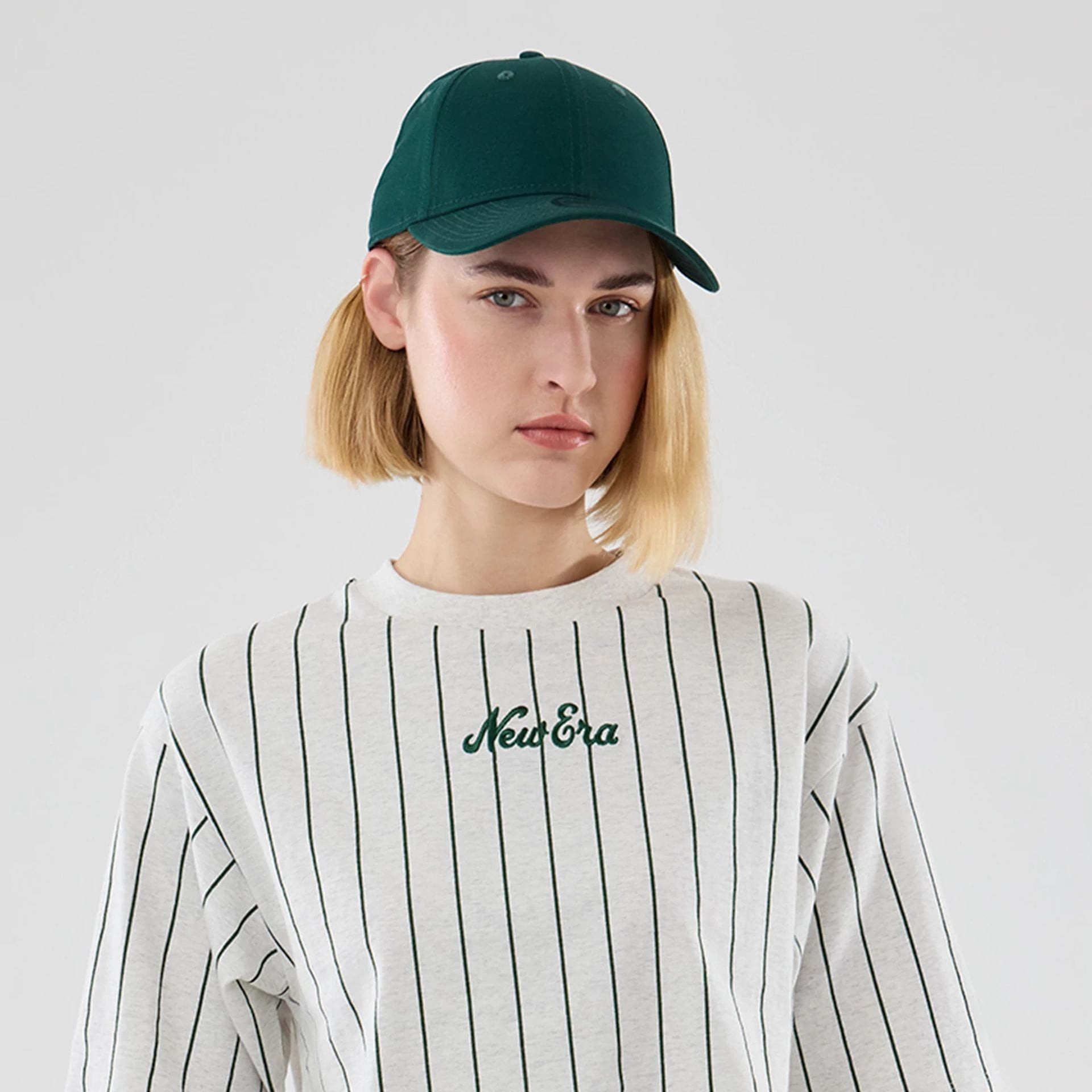 The model is wearing this Womens New Era Pinstripe Cropped T-shirt in pastel grey. 6