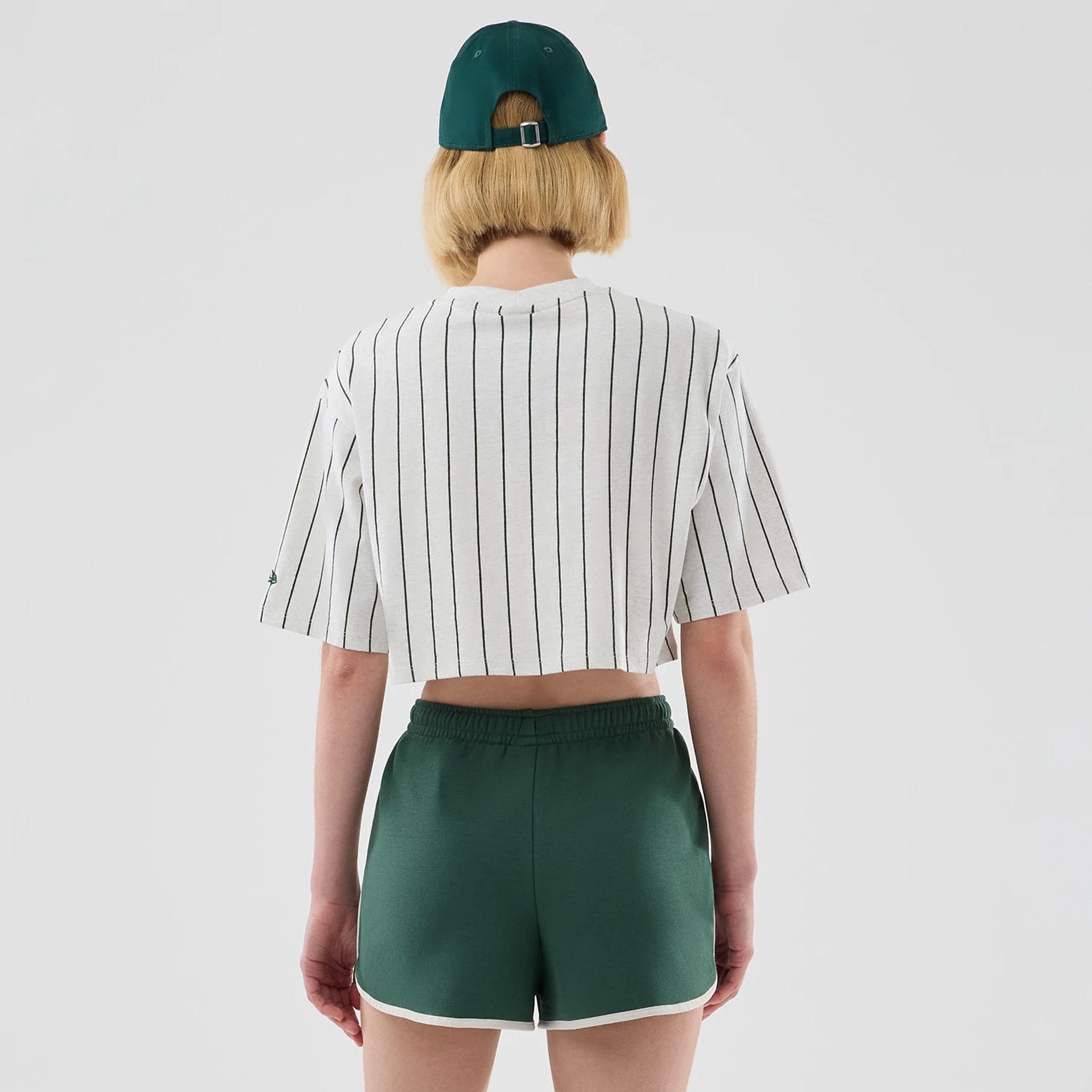 The model is wearing this Womens New Era Pinstripe Cropped T-shirt in pastel grey. 2