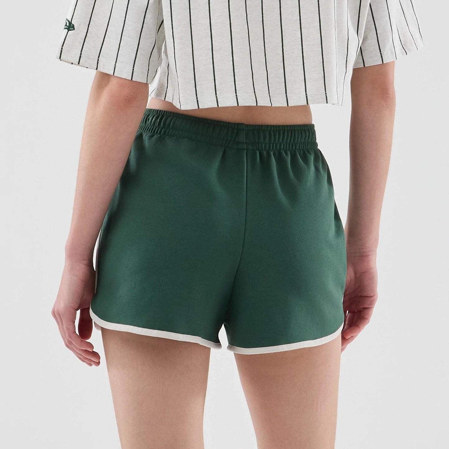 The model is wearing this Womens New Era Track Shorts in dark green. 7