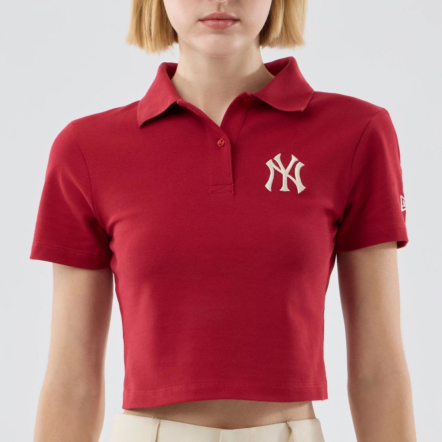 The model is wearing this Womens MLB New York Yankees Cropped Slim Polo T-shirt in dark red. 3