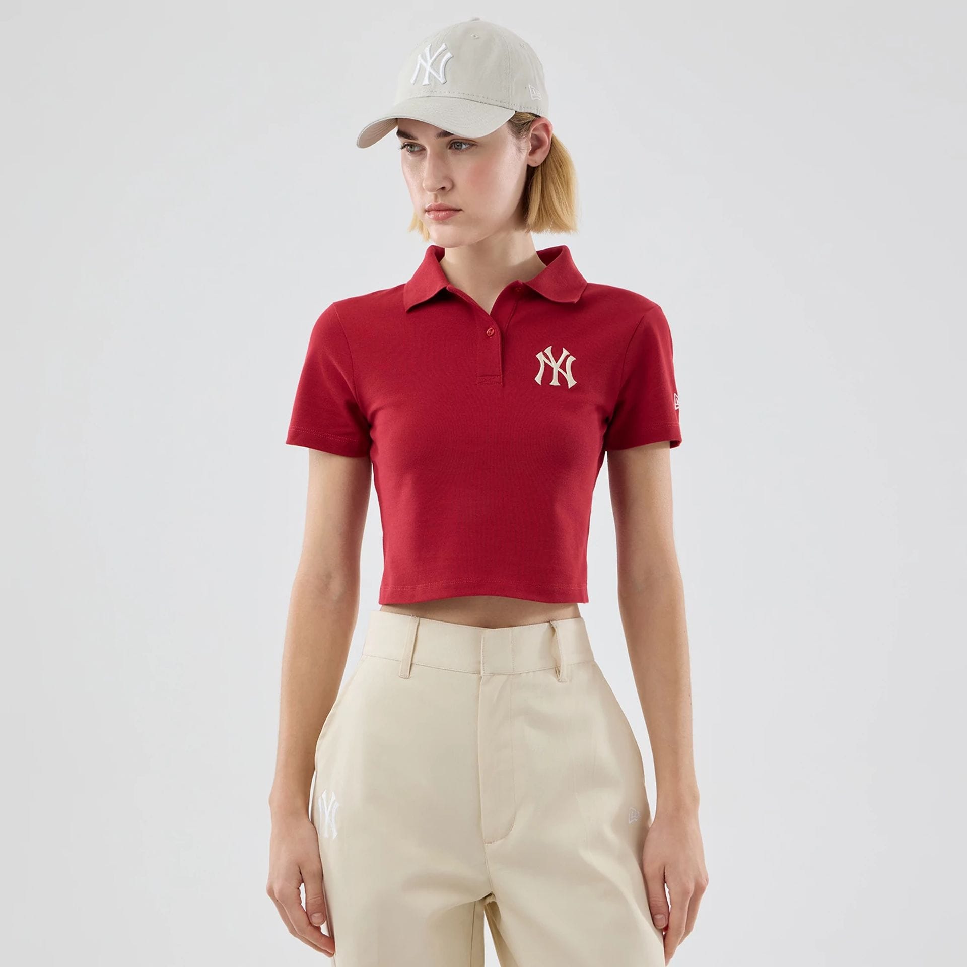 The model is wearing this Womens MLB New York Yankees Cropped Slim Polo T-shirt in dark red. 1