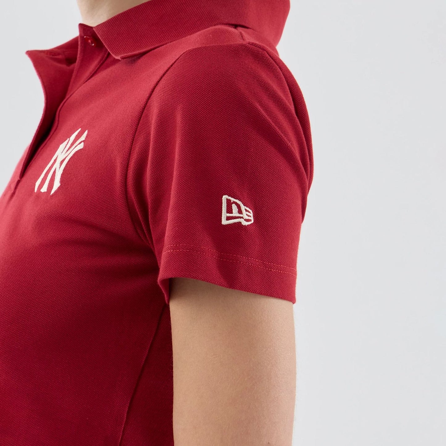 The model is wearing this Womens MLB New York Yankees Cropped Slim Polo T-shirt in dark red. 5