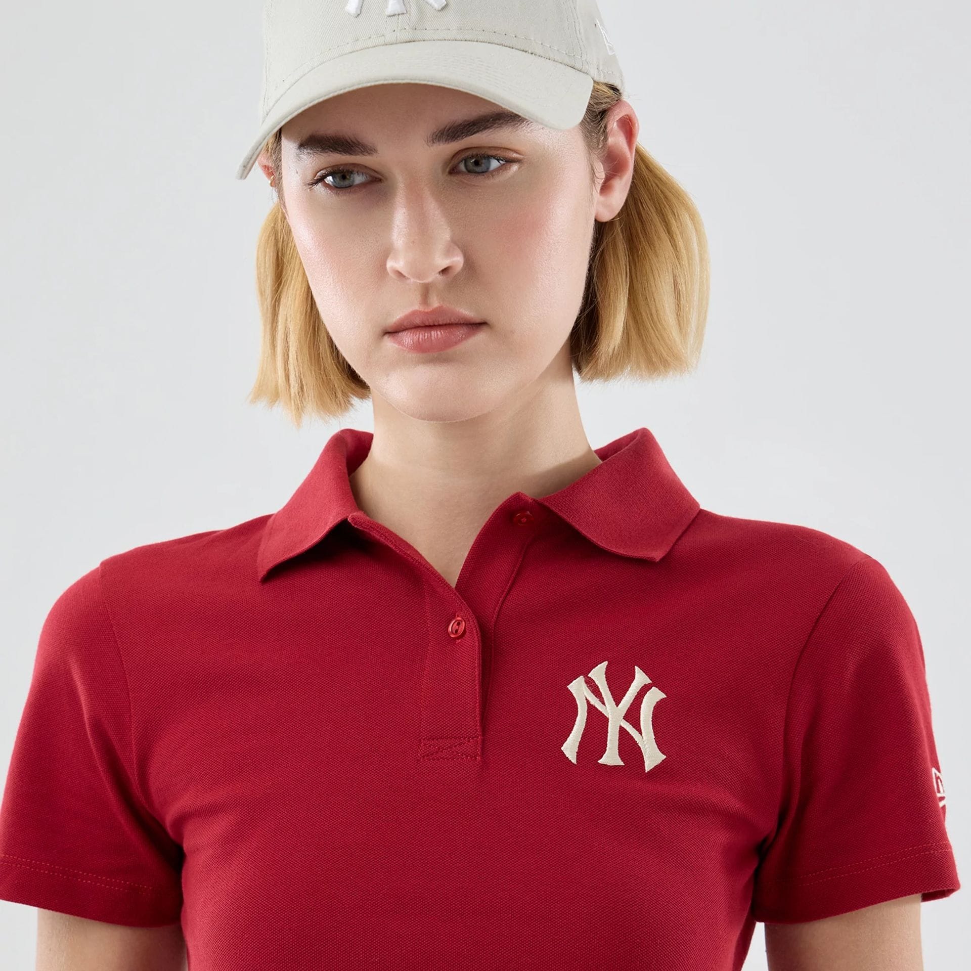 The model is wearing this Womens MLB New York Yankees Cropped Slim Polo T-shirt in dark red. 6