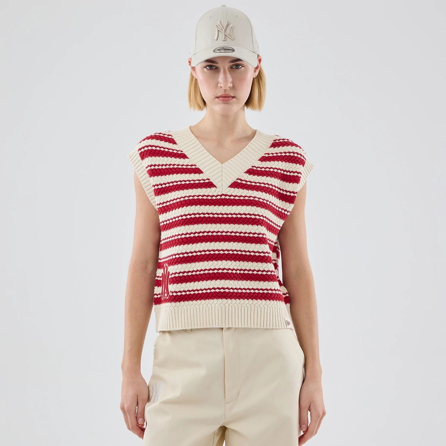 The model is wearing this Womens MLB Knit Stripe New York Yankees Sleeveless  V-neck Sweater in dark red. 1