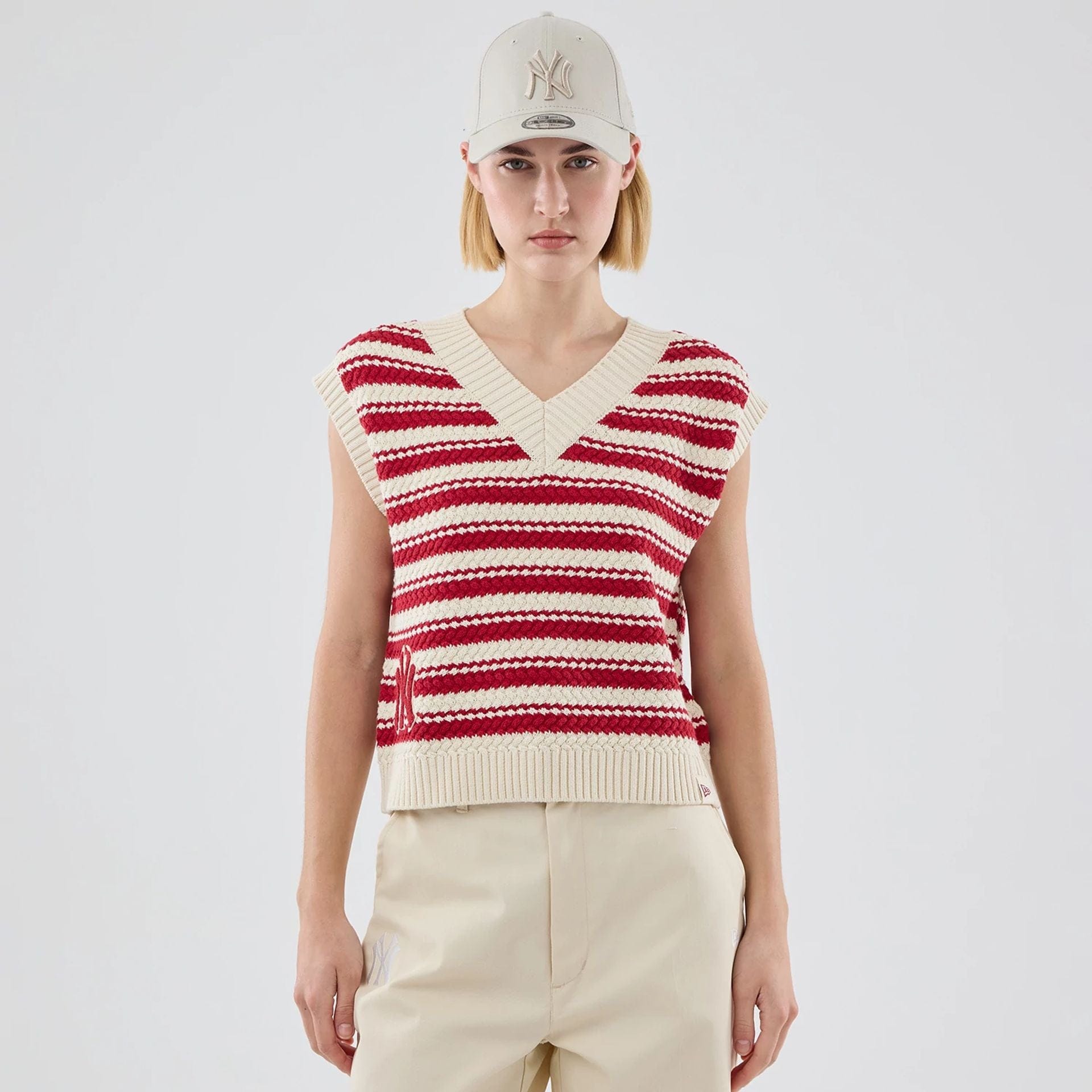 The model is wearing this Womens MLB Knit Stripe New York Yankees Sleeveless  V-neck Sweater in dark red. 1