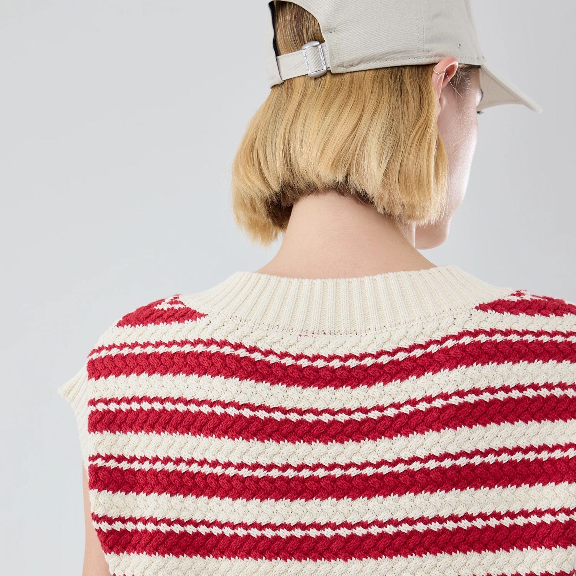 The model is wearing this Womens MLB Knit Stripe New York Yankees Sleeveless  V-neck Sweater in dark red. 7