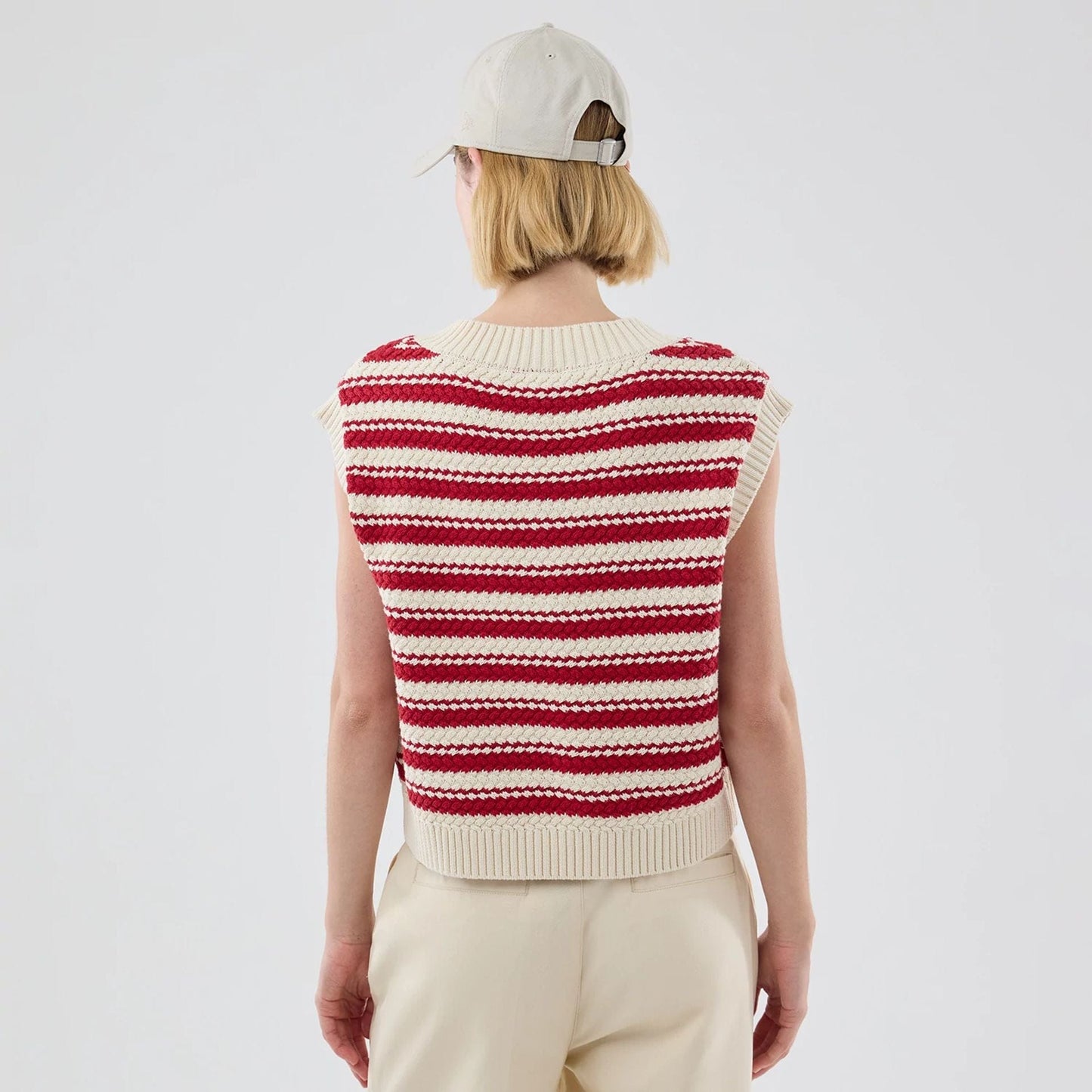 The model is wearing this Womens MLB Knit Stripe New York Yankees Sleeveless  V-neck Sweater in dark red. 2