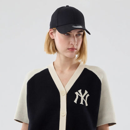 The model is wearing this Womens MLB Knit Stripe New York Yankees Short Sleeve Cardigan in black. 6