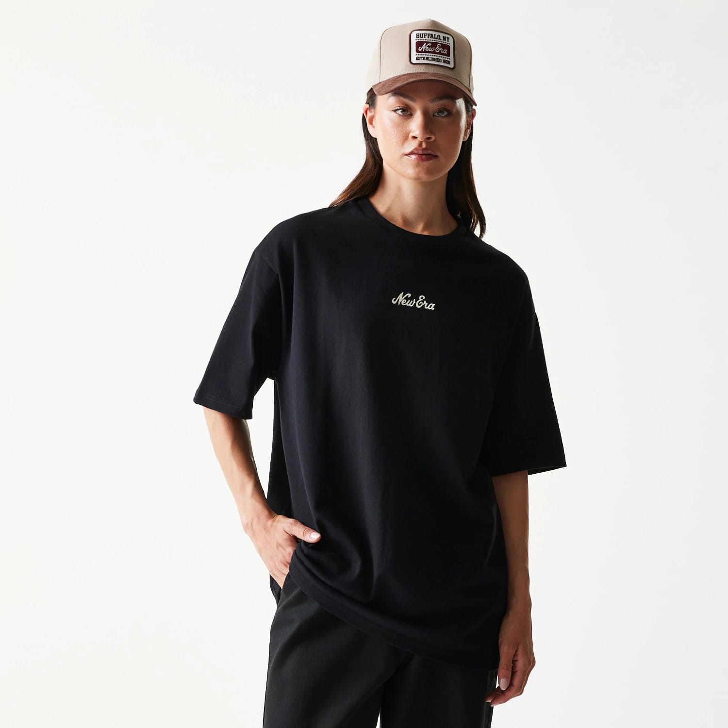 The model is wearing this New Era Heritage Script T-Shirt in black. 4