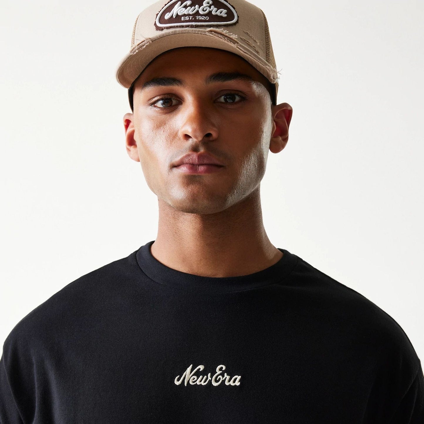 The model is wearing this New Era Script T-Shirt in black. 5