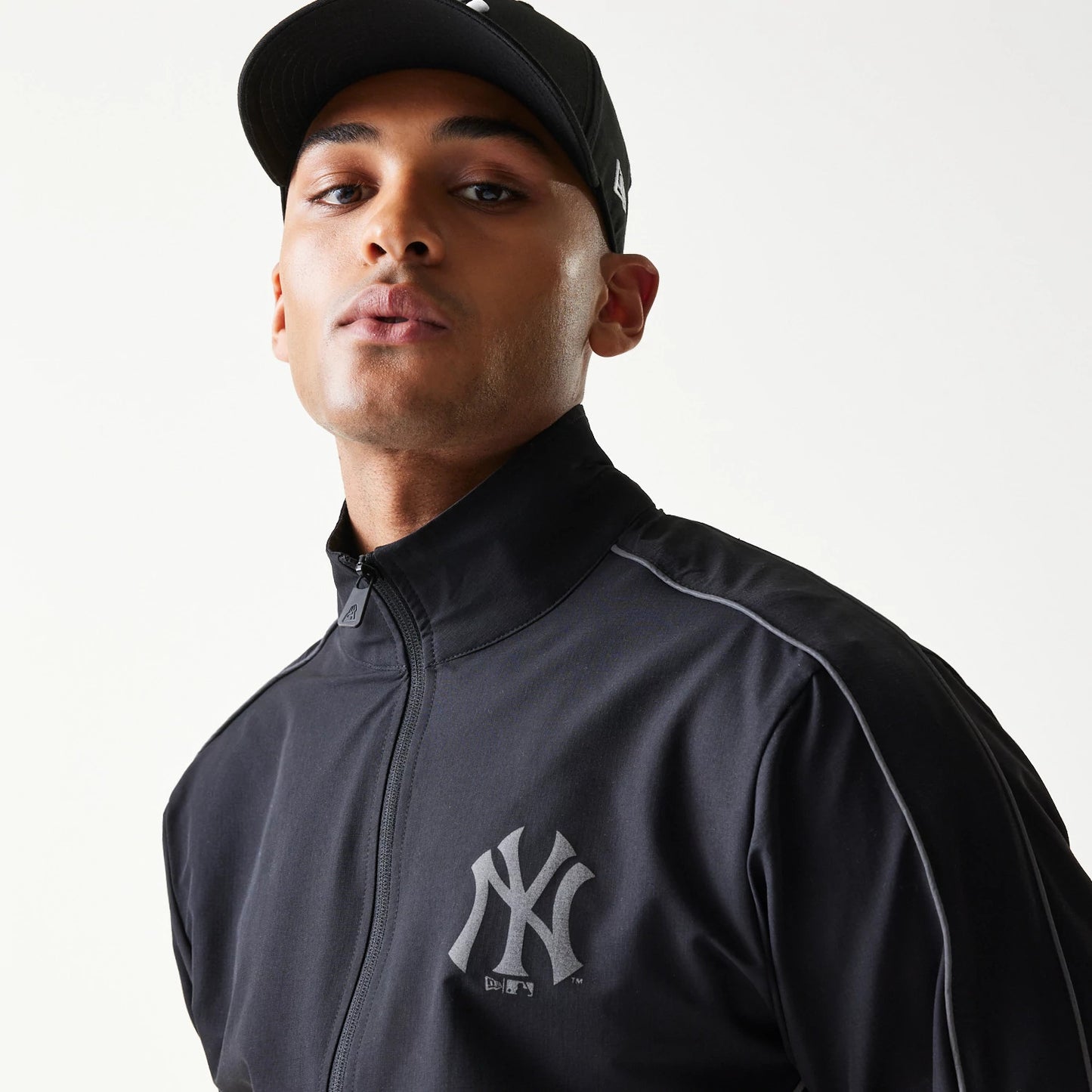 The model is wearing this MLB New York Yankees Track Jacket in black. 6