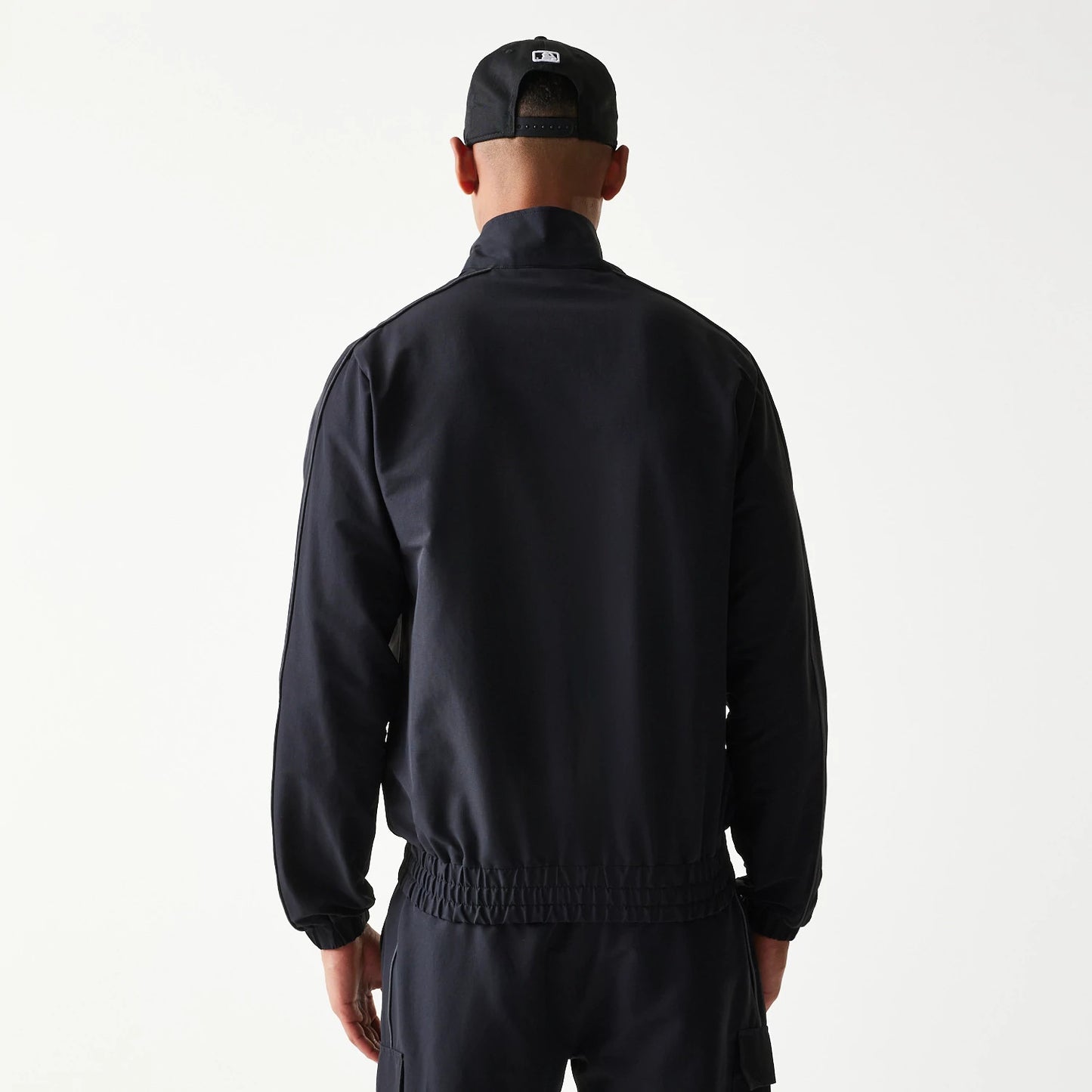 The model is wearing this MLB New York Yankees Track Jacket in black. 2