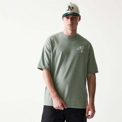 The model is wearing this New Era Floral Graphic Oversized T-Shirt in pastel green. 3
