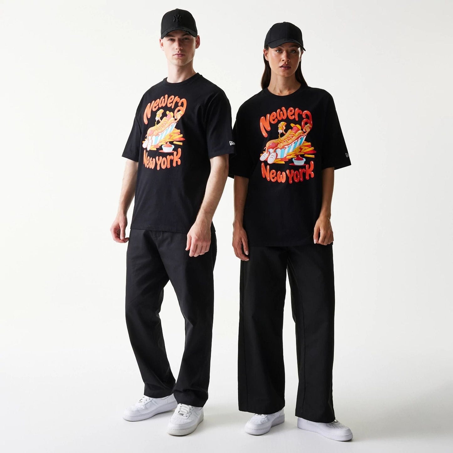 The model is wearing this New Era Hotdog Food Graphic Oversized T-Shirt in black. 1