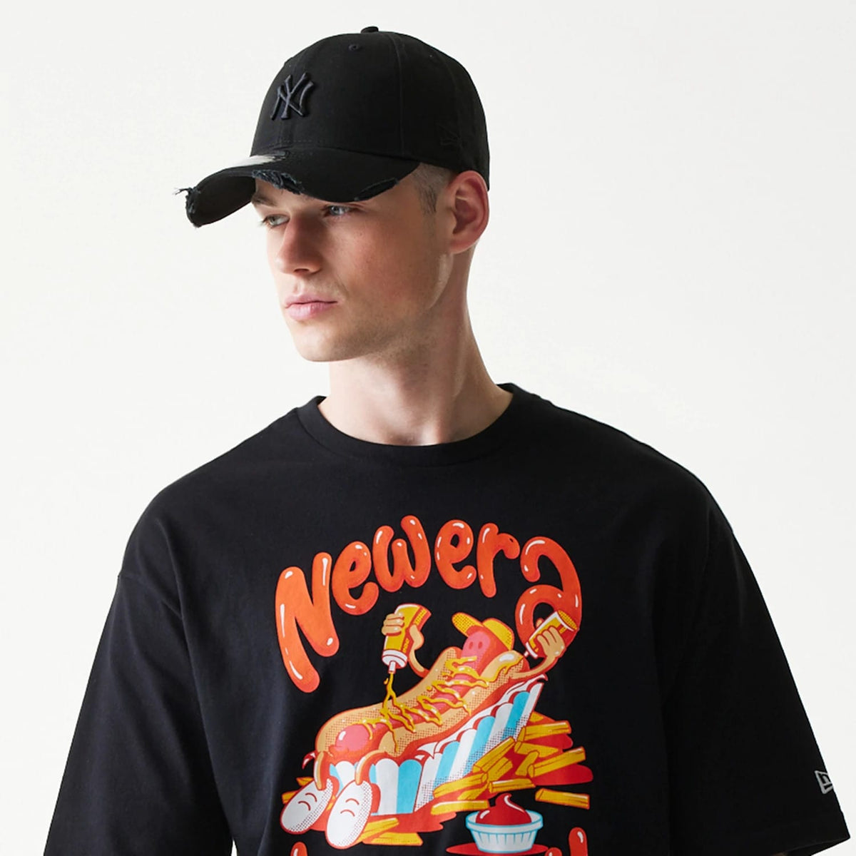 The model is wearing this New Era Hotdog Food Graphic Oversized T-Shirt in black. 5