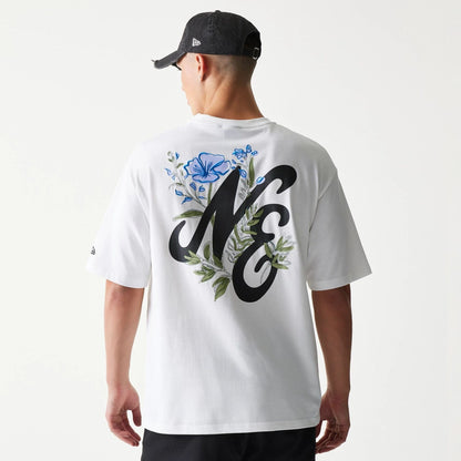 The model is wearing this New Era Floral Graphic Oversized T-Shirt in white. 2