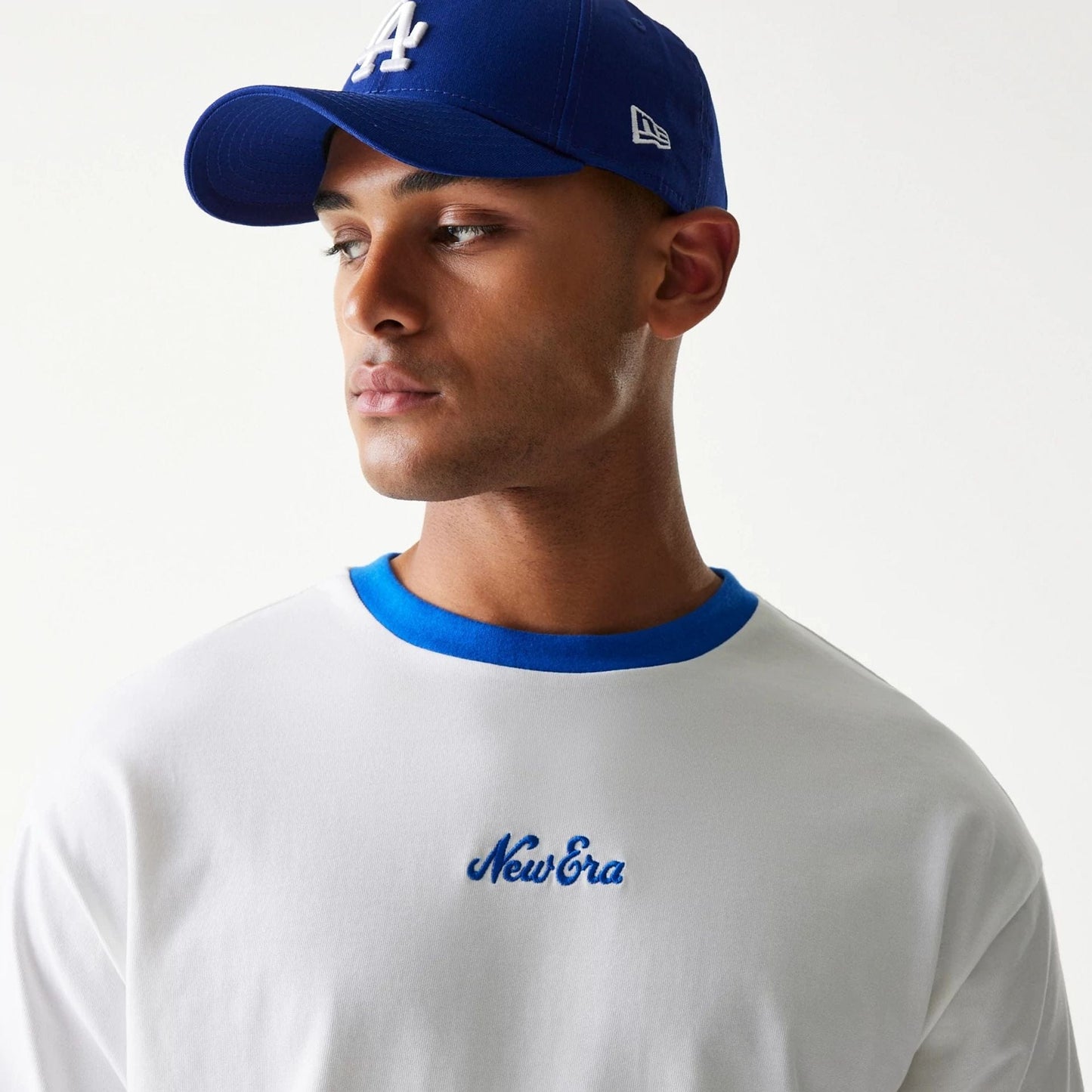 The model is wearing this New Era Script Oversized T-Shirt in white. 5